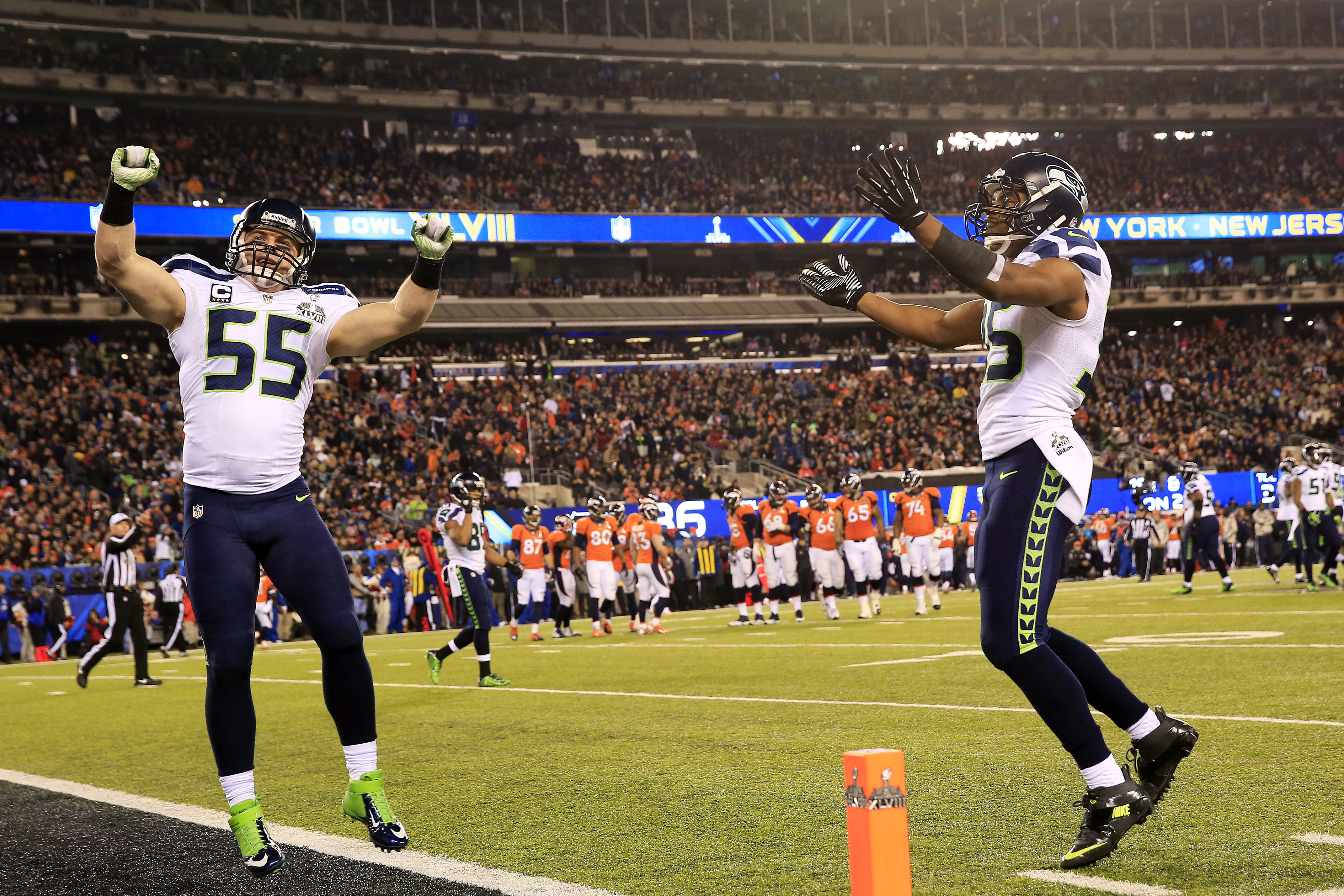EAST RUTHERFORD, NJ - FEBRUARY 02: Linebacker Heath Farwell #55 of the Seattle Seahawks celebrates with wide receiver Jermaine Kearse #15  during Super Bowl XLVIII at MetLife Stadium on February 2, 2014 in East Rutherford, New Jersey.The Seahawks beat the Broncos 43-8.   (Photo by Jamie Squire/Getty Images)