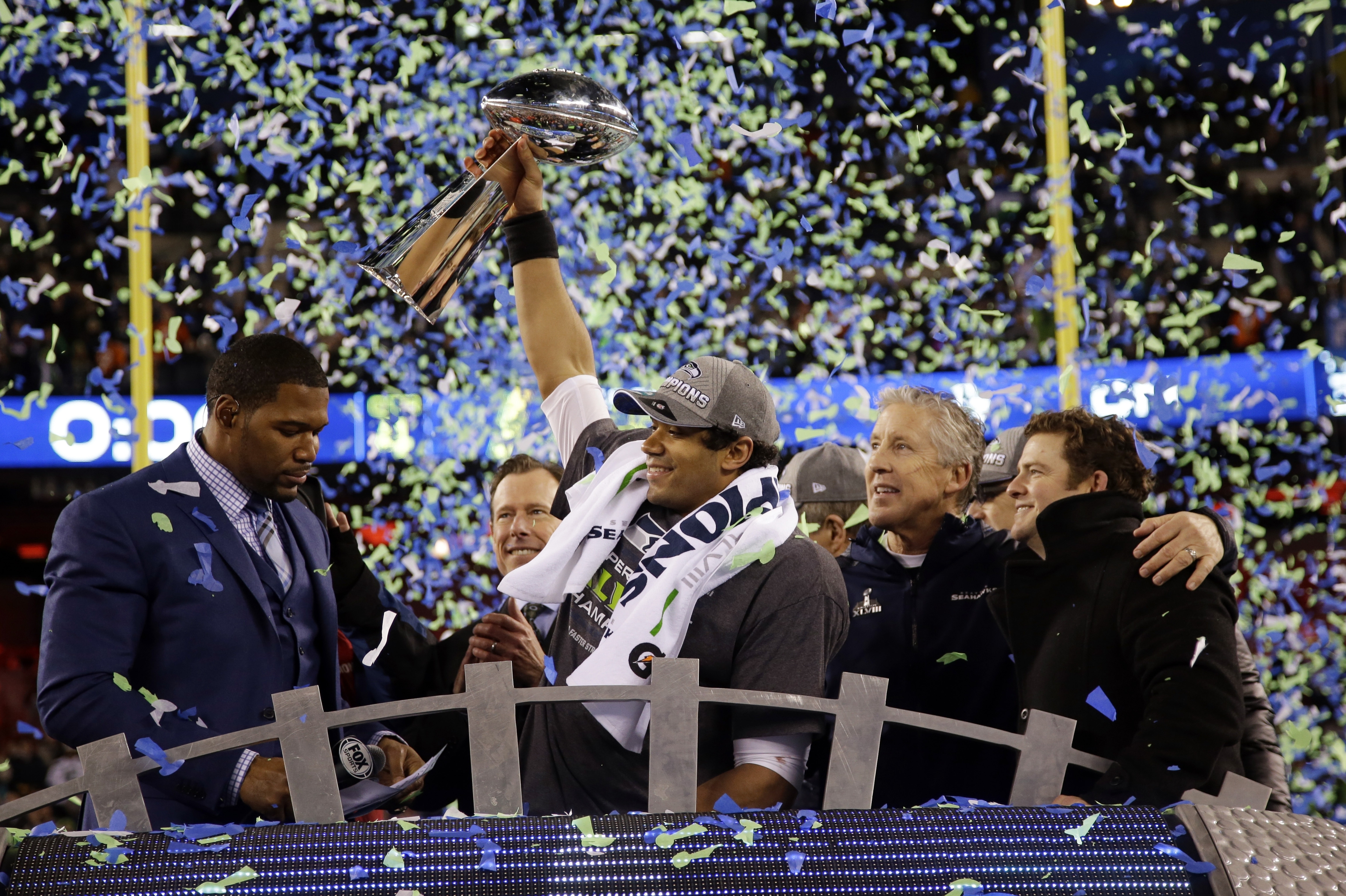 Seattle Seahawks' Russell Wilson (3) raises the Vince Lombardi Trophy after the NFL Super Bowl XLVIII football game against the Denver Broncos, Sunday, Feb. 2, 2014, in East Rutherford, N.J. The Seahawks won 43-8. (AP Photo/Matt Slocum)