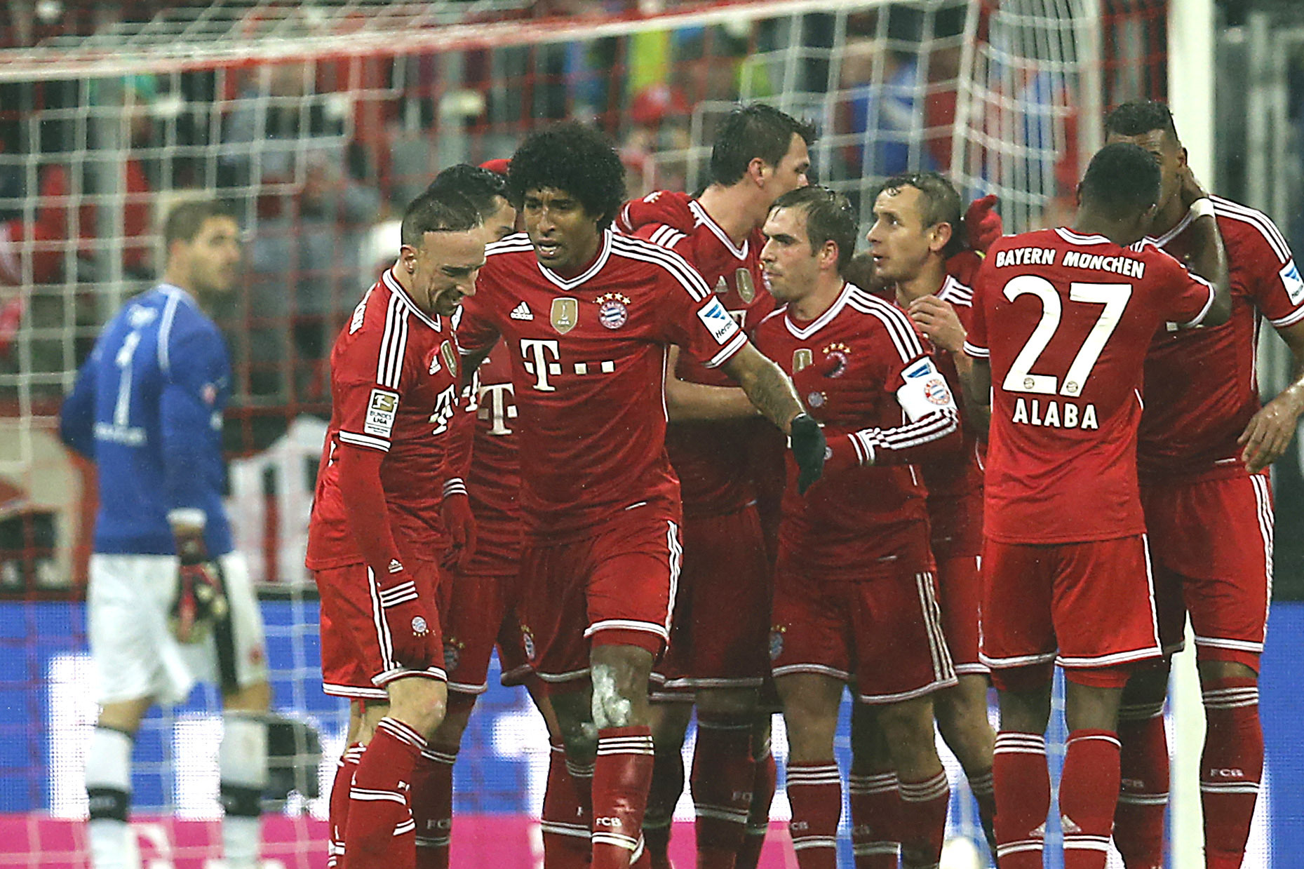 Munich teammates celebrate after scoring during the German first division Bundesliga soccer match between Bayern Munich and Eintracht Frankfurt in Munich , Germany, Sunday, Feb. 2, 2014. (AP Photo/Frank Augstein)