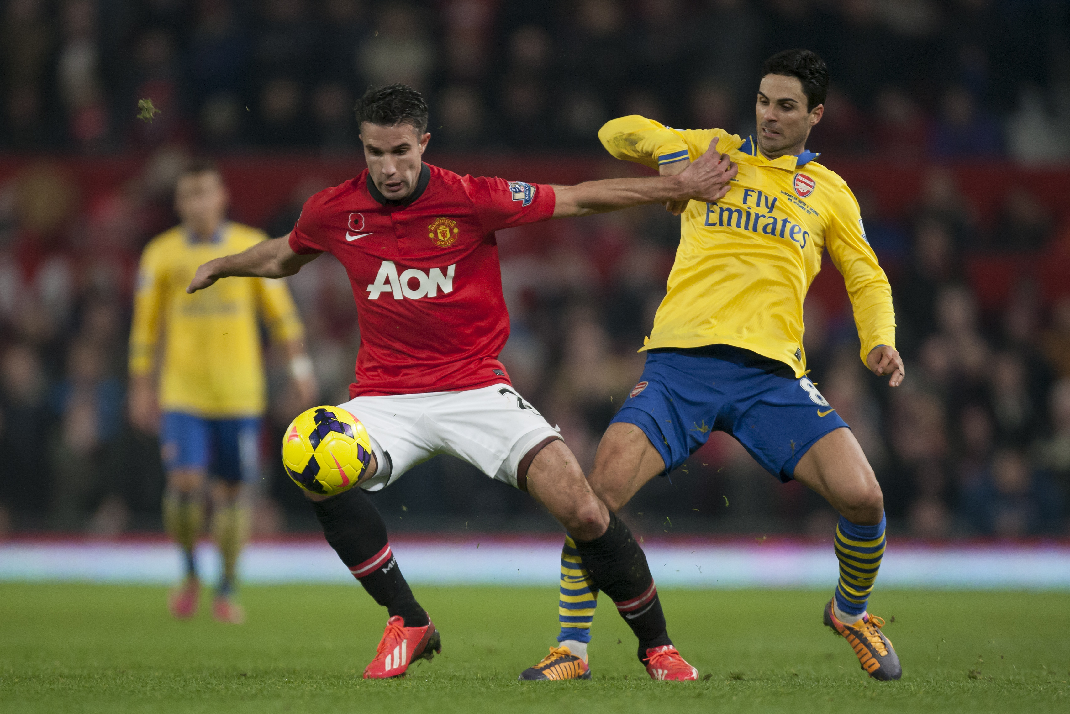 Manchester United's Robin van Persie, left, fights for the ball against Arsenal's Mikel Arteta during their English Premier League soccer match at Old Trafford Stadium, Manchester, England, Saturday Nov. 10, 2013. (AP Photo/Jon Super)