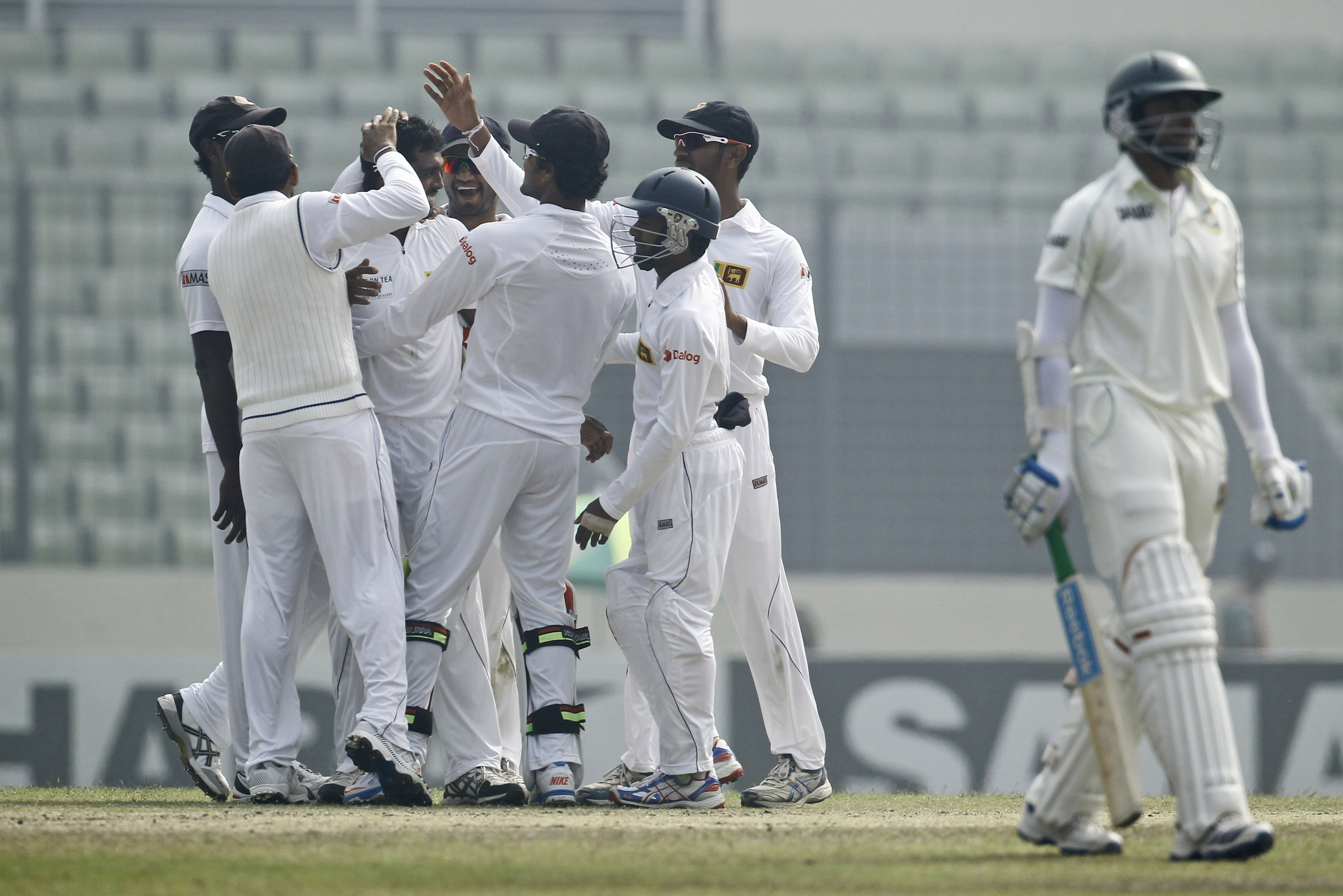 Sri Lanka’s Dilruwan Perera, third left, celebrates with teammates the wicket of Bangladesh's Shakib Al Hasan, right, on the fourth day of their first test cricket match in Dhaka, Bangladesh, Thursday, Jan. 30, 2014. (AP Photo/A.M. Ahad)