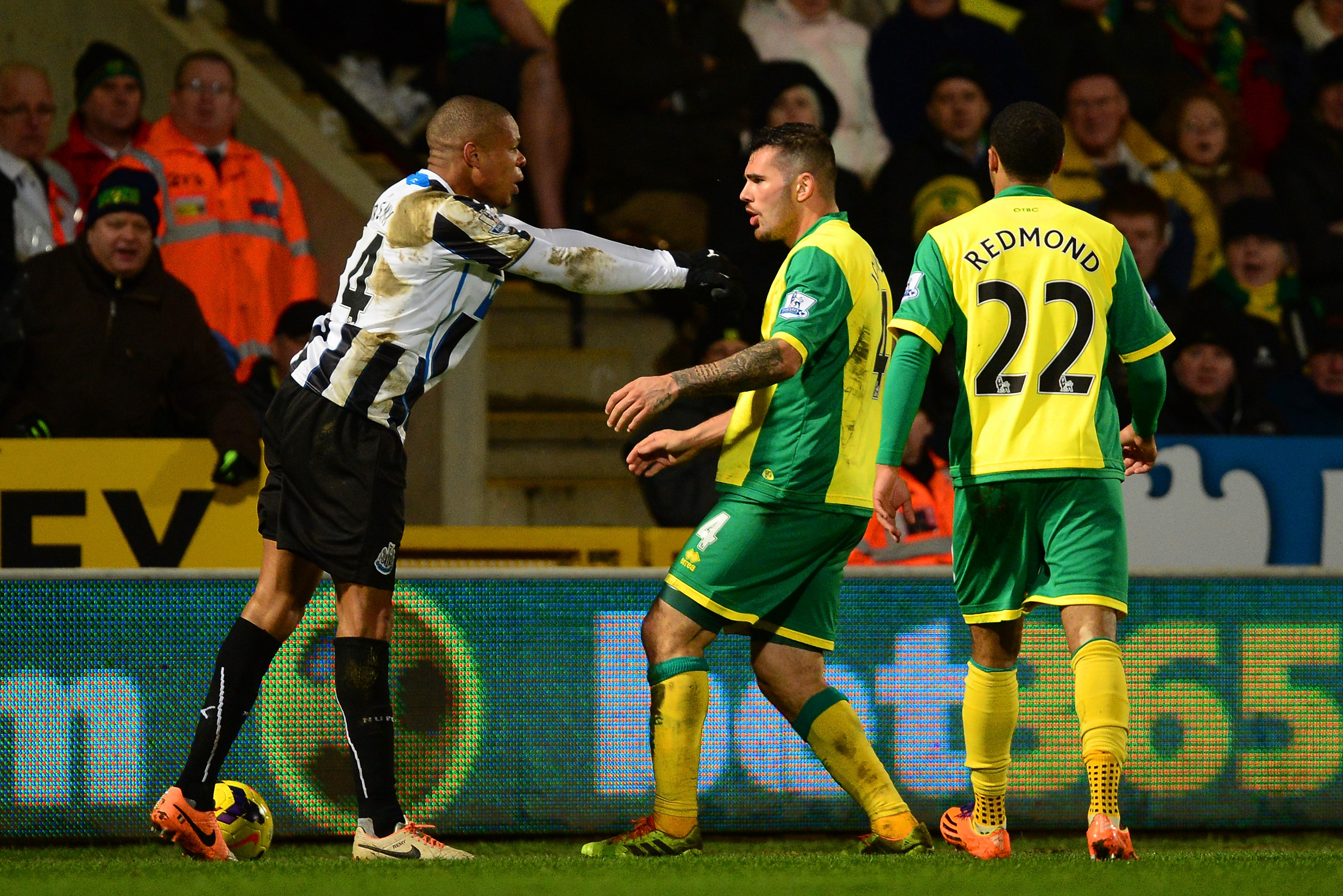 NORWICH, ENGLAND - JANUARY 28:  Loic Remy of Newcastle United and Bradley Johnson of Norwich City come to blows during the Barclays Premier League match between Norwich City and Newcastle United at Carrow Road on January 28, 2014 in Norwich, England.  (Photo by Jamie McDonald/Getty Images)