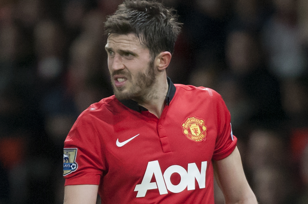 Manchester United's Michael Carrick walks from the pitch after being injured during his team's English League Cup semifinal second leg soccer match against Sunderland at Old Trafford Stadium, Manchester, England, Wednesday Jan. 22, 2014. (AP Photo/Jon Super)