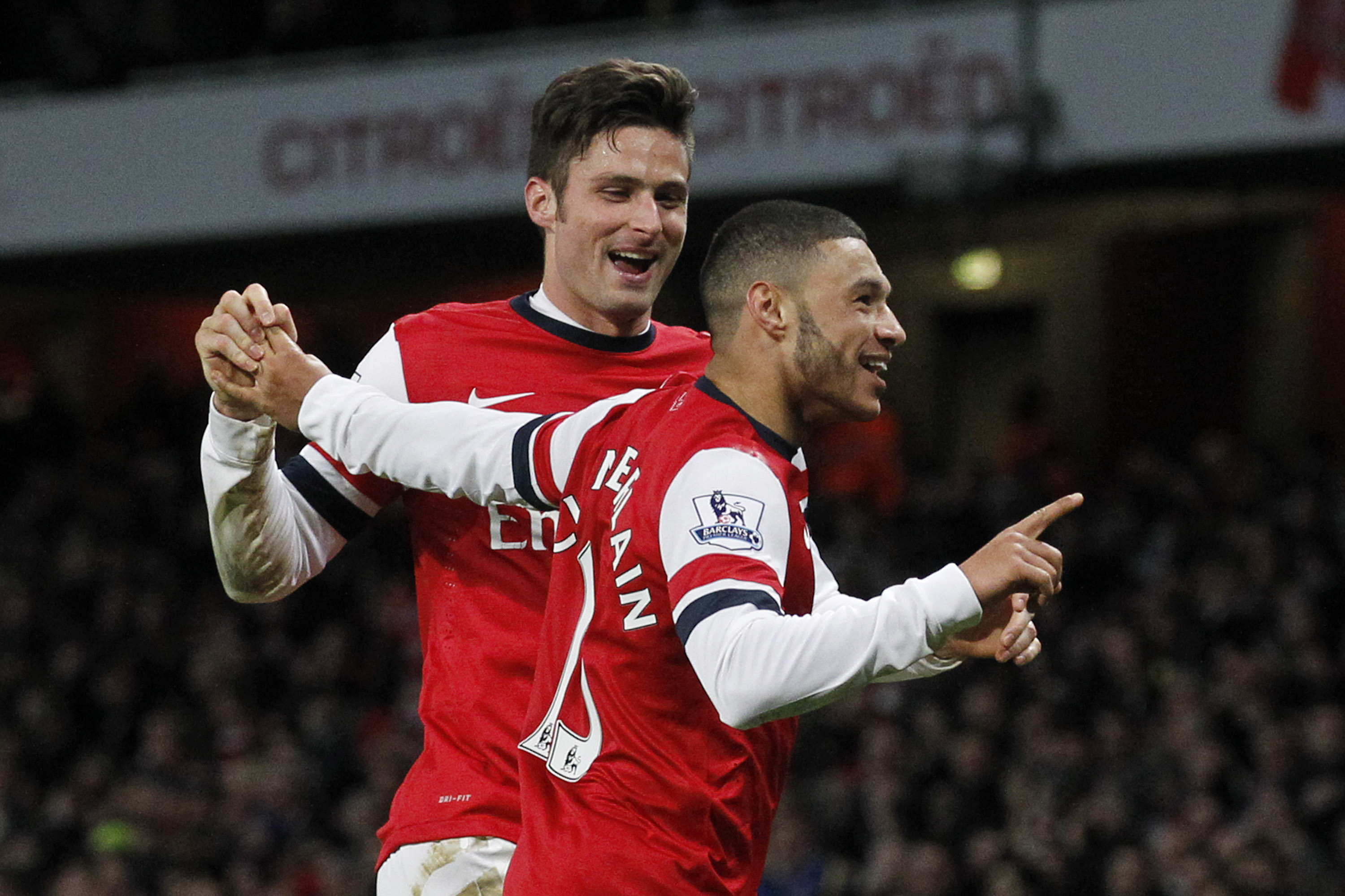 Arsenal's Alex Oxlade-Chamberlain, right, celebrates his his second against Crystal Palace with teammate Olivier Giroud during their English Premier League soccer match at Emirates Stadium in London, Sunday, Feb. 2, 2014. (AP Photo/Sang Tan)