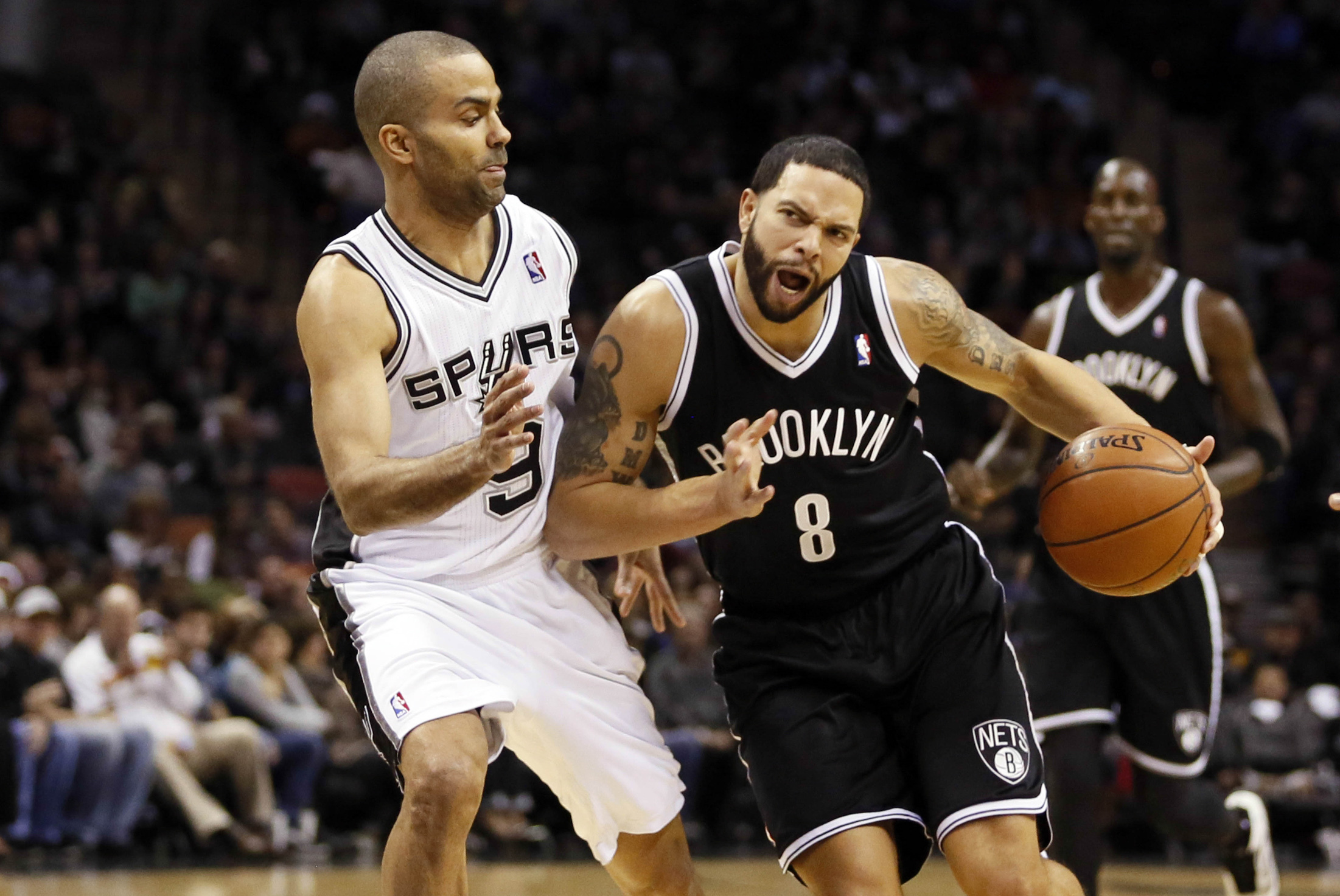 Dec 31, 2013; San Antonio, TX, USA; Brooklyn Nets guard Deron Williams (8) drives to the basket while guarded by San Antonio Spurs guard Tony Parker (9) during the first half at AT&T Center. Mandatory Credit: Soobum Im-USA TODAY Sports