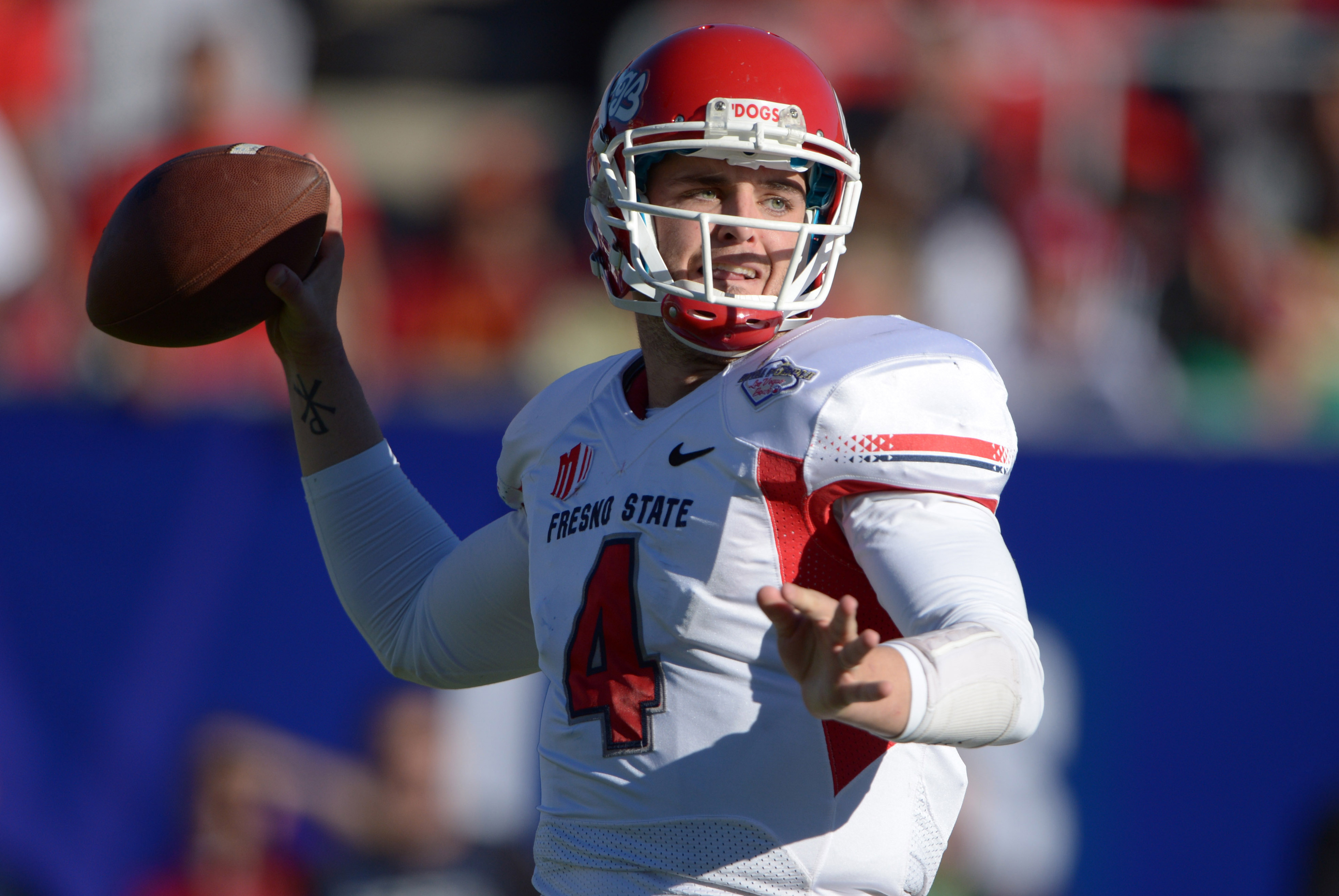 Dec 21, 2013; Las Vegas, NV, USA; Fresno State Bulldogs quarterback Derek Carr (4) throws a pass against the Southern California Trojans in the Las Vegas Bowl at Sam Boyd Stadium. Mandatory Credit: Kirby Lee-USA TODAY Sports