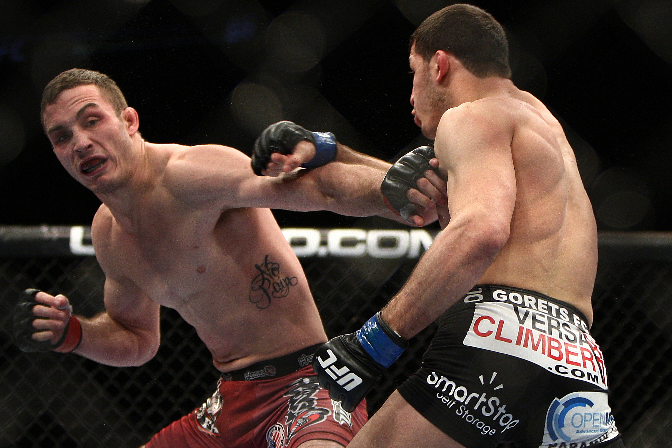 Tony Martin, left, tries to duck a punch by Rashid Magomedov, of Russia, during the first round of a UFC 169 lightweight mixed marshall arts bout in Newark, N.J., Saturday, Feb. 1, 2014. Magomedov won by unanimous decision. (AP Photo/Tim Larsen)