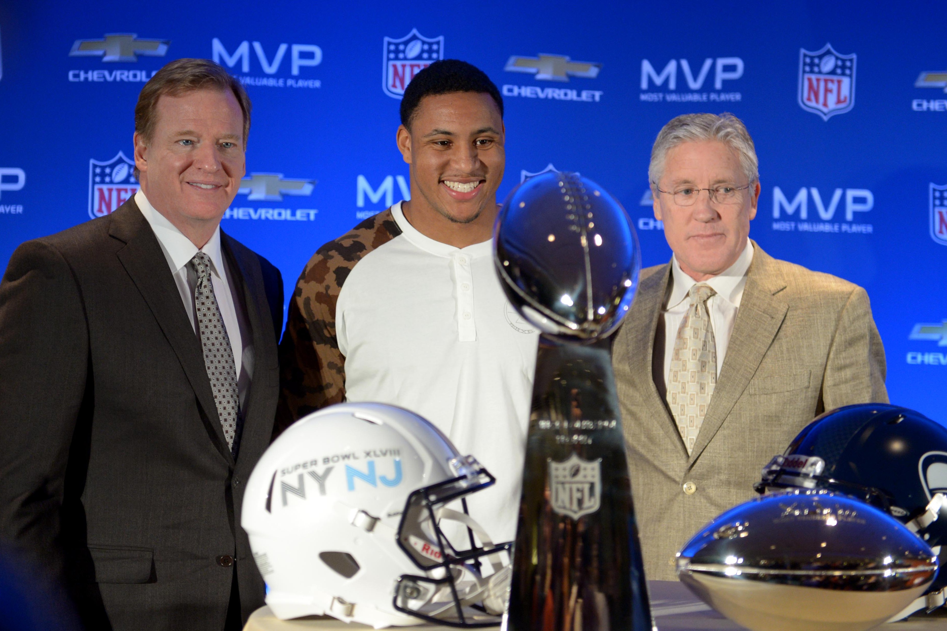 Feb 3, 2014; New York, NY, USA; NFL commissioner Roger Goodell (left) poses with Seattle Seahawks head coach Pete Carroll (right) and outside linebacker Malcolm Smith (middle) behind the Super Bowl MVP trophy and Vince Lombardi Trophy during the winning team press conference the day after Super Bowl XLVIII at Sheraton New York Times Square. Mandatory Credit: Kirby Lee-USA TODAY Sports