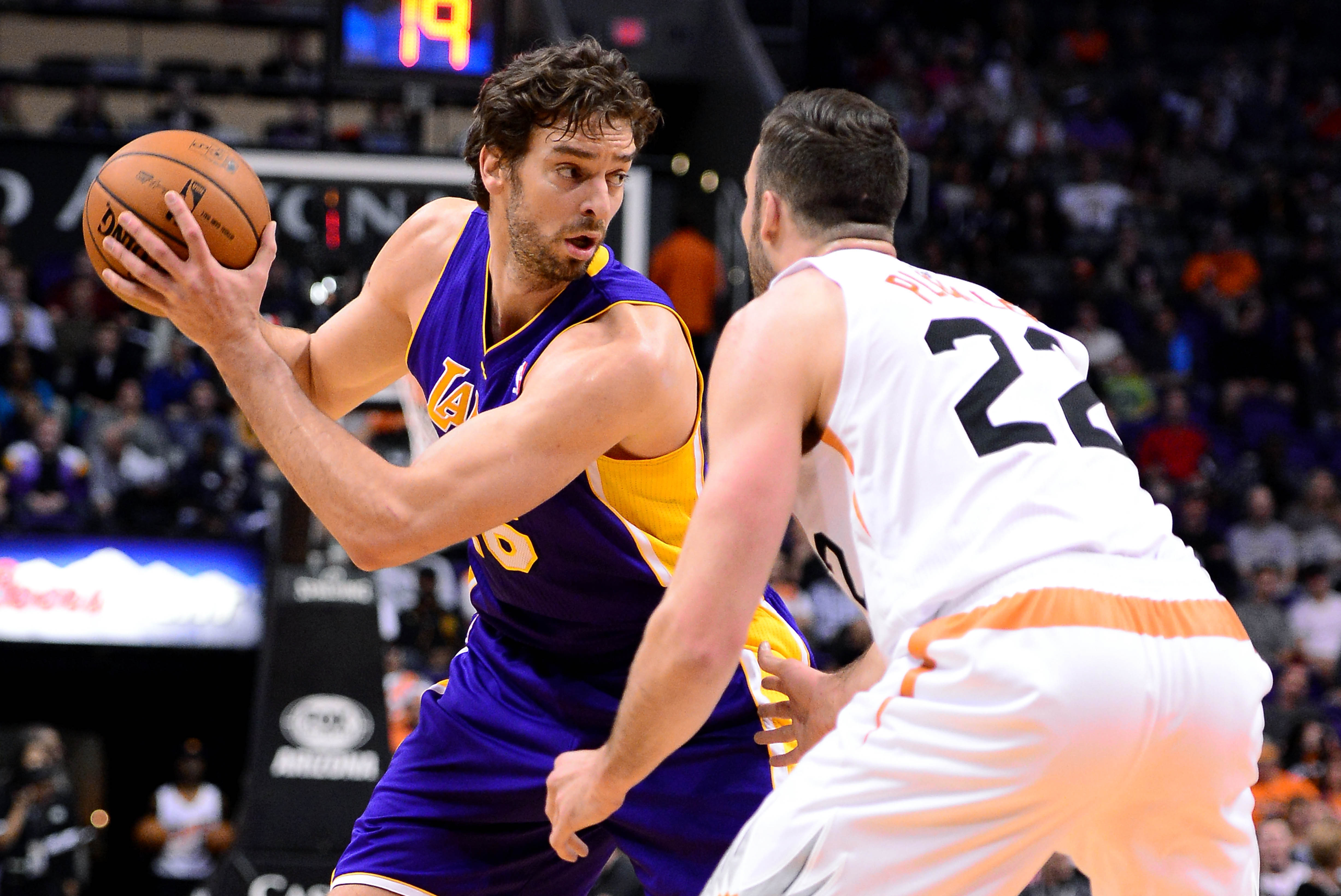 Jan 15, 2014; Phoenix, AZ, USA; Los Angeles Lakers center Pau Gasol (16) handles the ball against the Phoenix Suns forward Miles Plumlee (22) in the first half at US Airways Center. Mandatory Credit: Jennifer Stewart-USA TODAY Sports