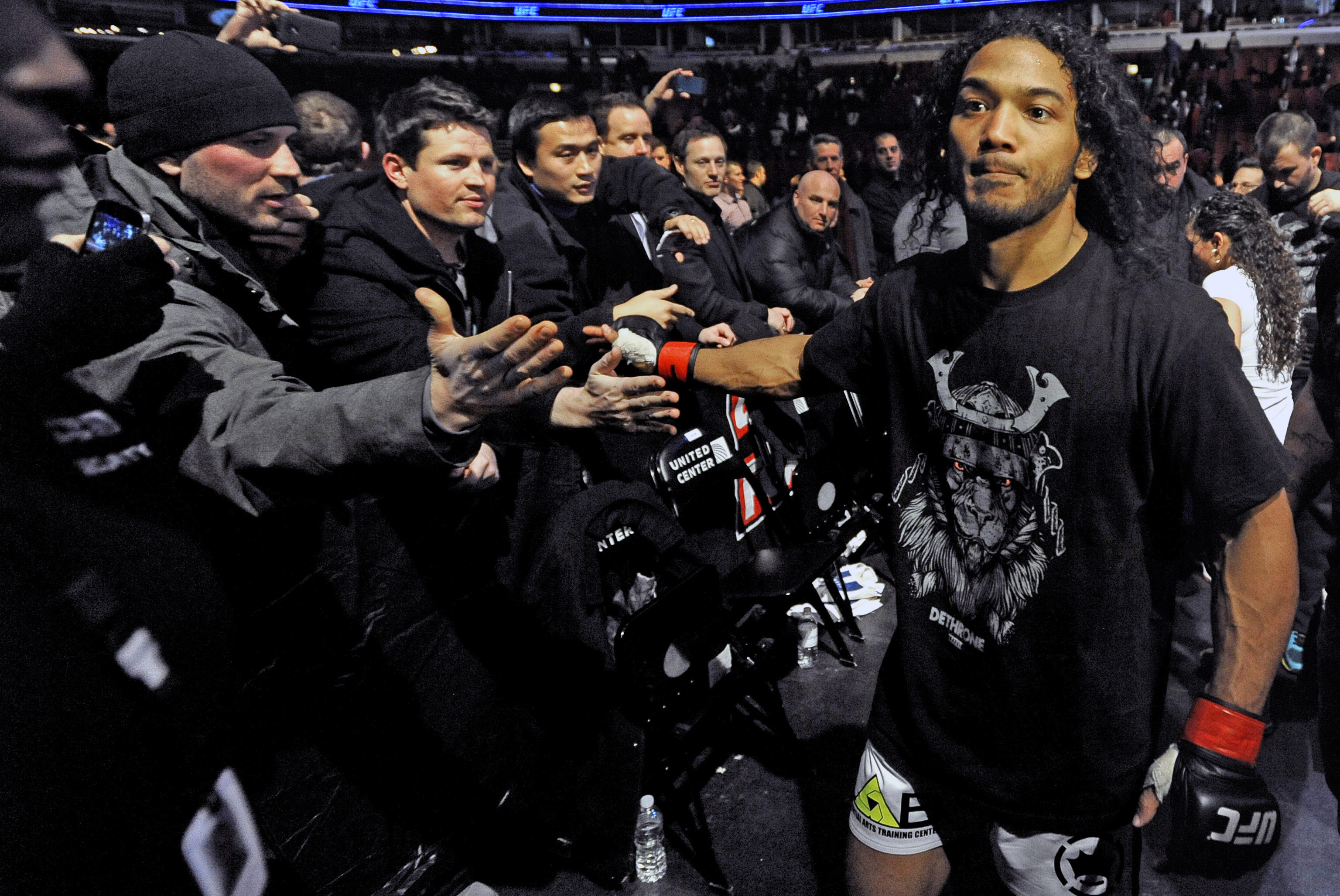 Benson Henderson celebrates with fans after defeating Josh Thomson during the main event of the UFC mixed martial arts match in Chicago, Saturday, Jan., 25, 2014. (AP Photo/Paul Beaty)