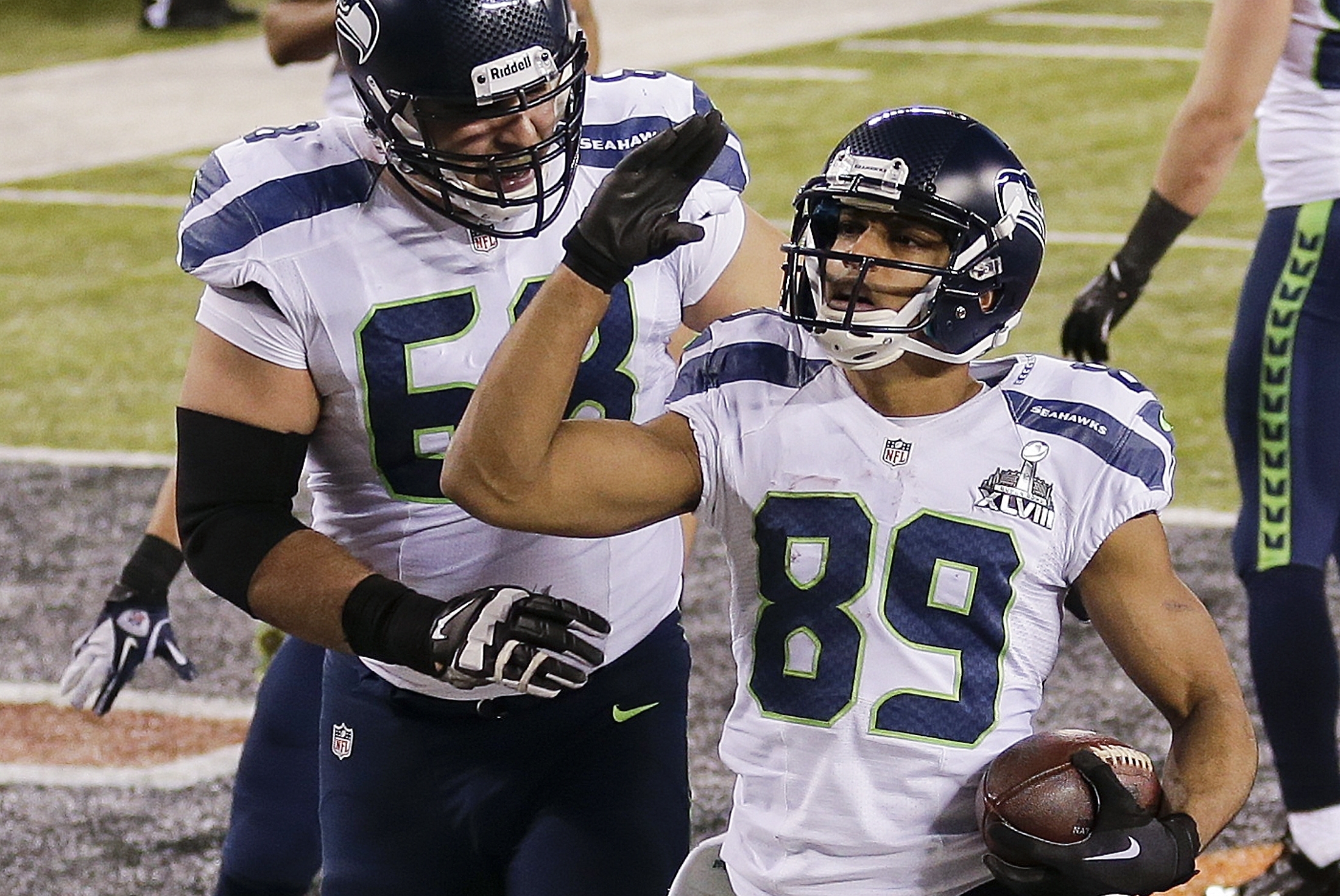 Seattle Seahawks wide receiver Doug Baldwin (89) celebrates with tackle Breno Giacomini (68) after scoring a touchdown against the Denver Broncos during the second half of the NFL Super Bowl XLVIII football game, Sunday, Feb. 2, 2014, in East Rutherford, N.J. (AP Photo/Gregory Bull)