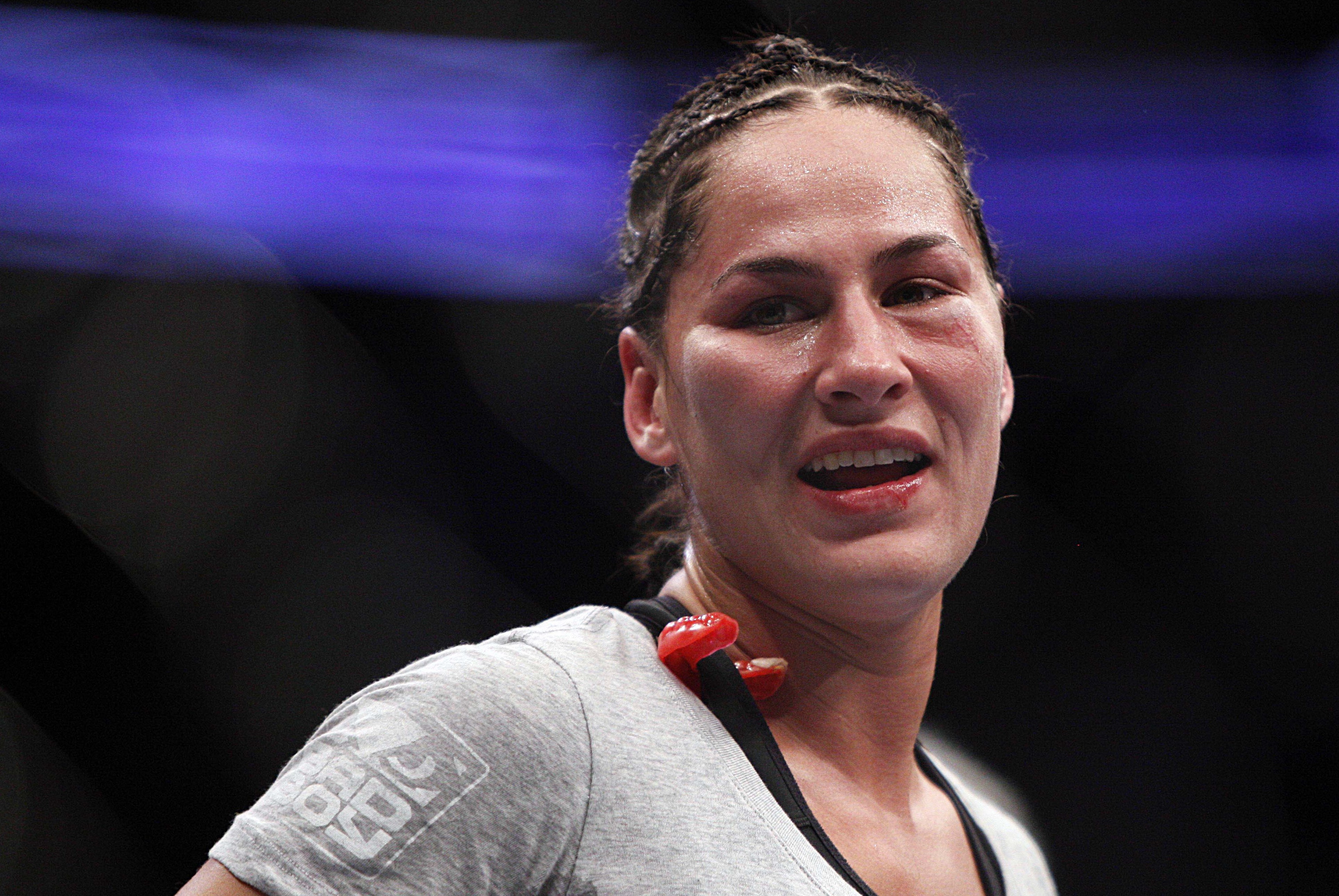 Oct 19, 2013; Houston, TX, USA; Jessica Eye (blue gloves) reacts after being defeated by decision by Sarah Kaufman (not pictured) in their women's bantamweight bout during UFC 166 at Toyota Center. Mandatory Credit: Andrew Richardson-USA TODAY Sports