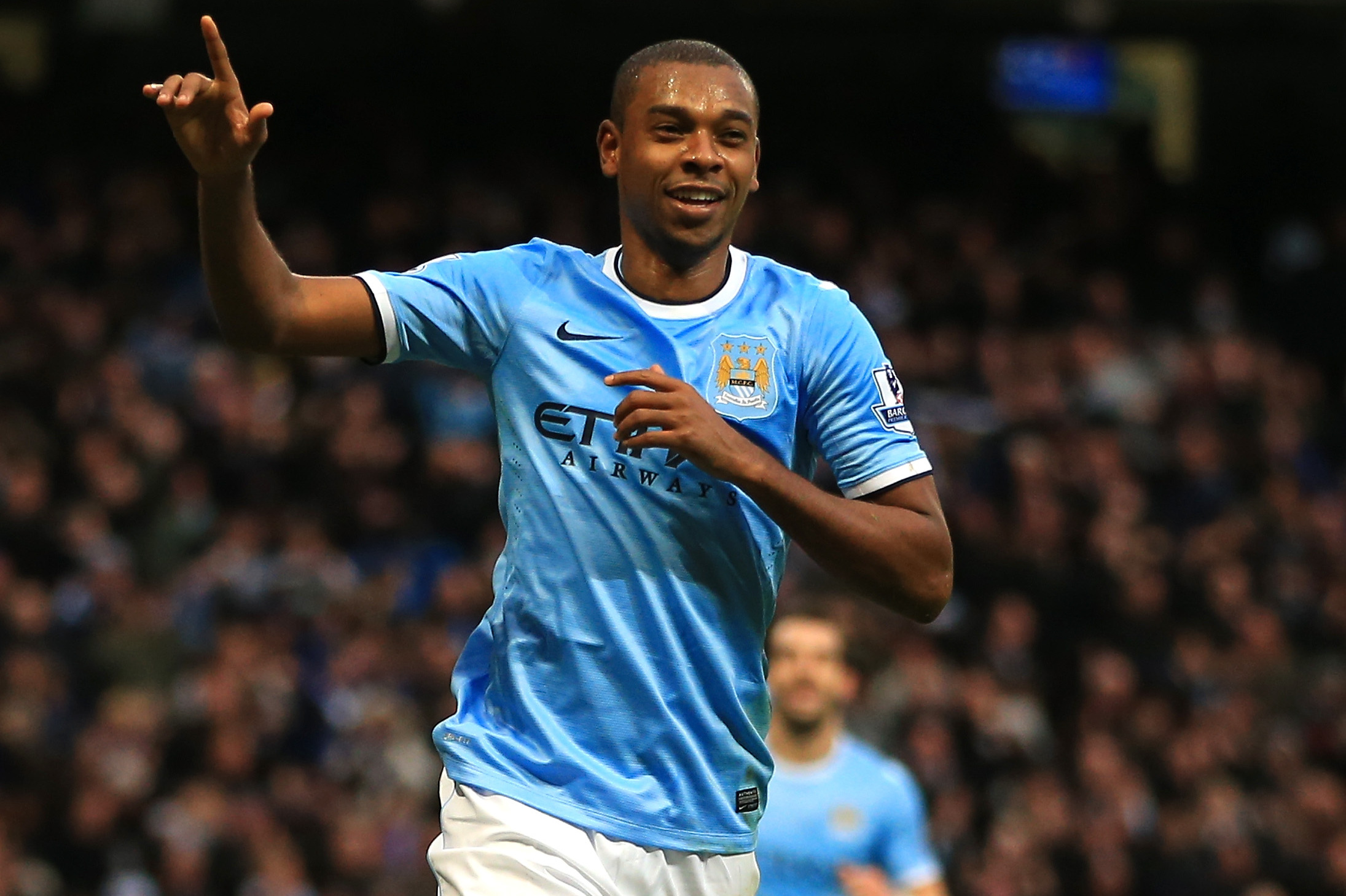 MANCHESTER, ENGLAND - DECEMBER 14:  Fernandinho of Manchester City celebrates scoring their fifth goal during the Barclays Premier League match between Manchester City and Arsenal at Etihad Stadium on December 14, 2013 in Manchester, England.  (Photo by Richard Heathcote/Getty Images)