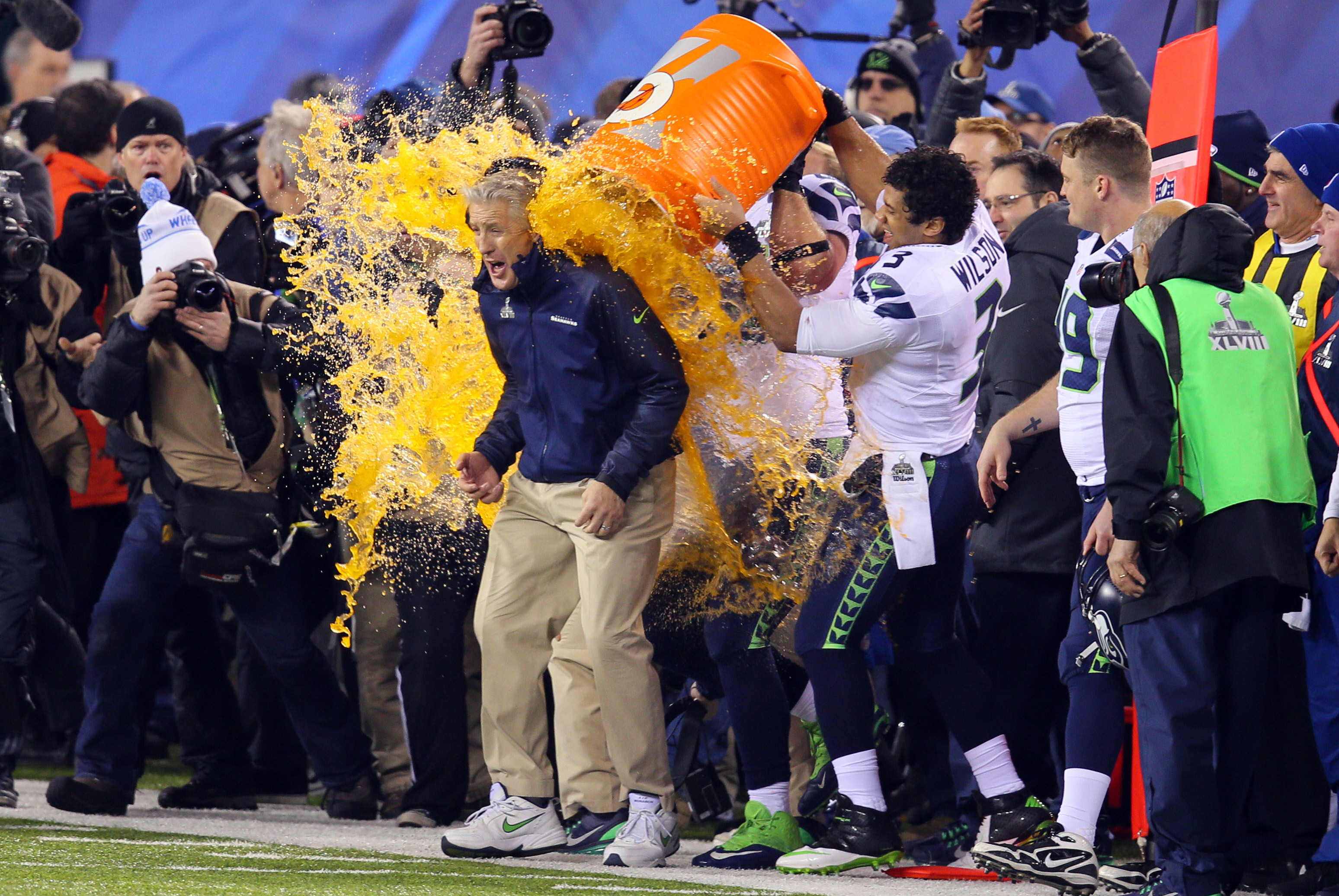 Feb 2, 2014; East Rutherford, NJ, USA; Seattle Seahawks head coach Pete Carroll gets gatorade dump on him by quarterback Russell Wilson (3) during the second half against the Denver Broncos in Super Bowl XLVIII at MetLife Stadium.  Mandatory Credit: Adam Hunger-USA TODAY Sports