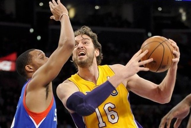Los Angeles Lakers forward Pau Gasol (16), of Spain, battles Philadelphia 76ers forward Evan Turner, left, as he moves to the basket in the first half of an NBA basketball game, Tuesday, Jan. 1, 2013, in Los Angeles. (AP Photo/Gus Ruelas)