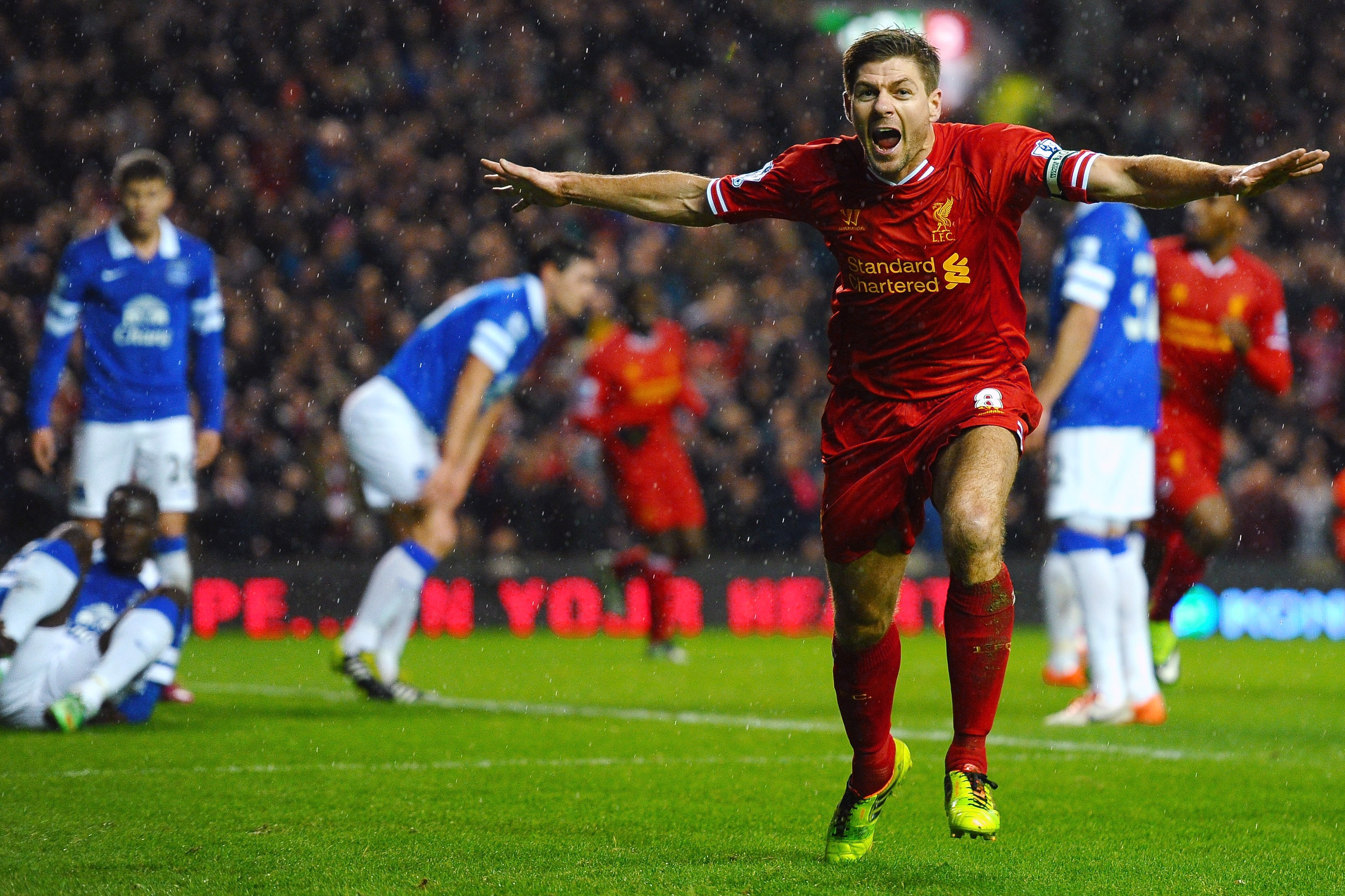 LIVERPOOL, ENGLAND - JANUARY 28:  Steven Gerrard of Liverpool celebrates after scoring the opening goal during the Barclays Premier League match between Liverpool and Everton at Anfield on January 28, 2014 in Liverpool, England.  (Photo by Laurence Griffiths/Getty Images)