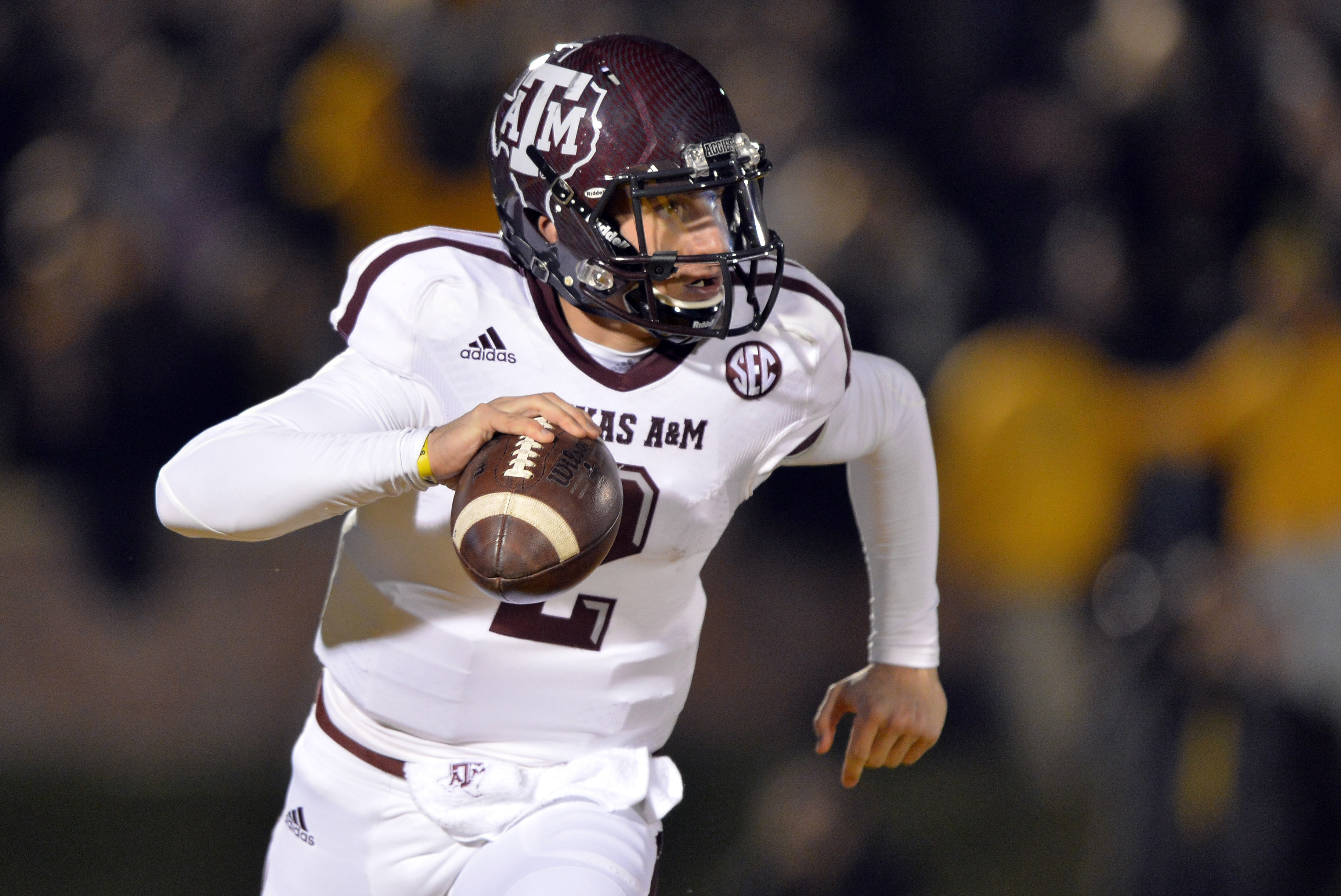 Nov 30, 2013; Columbia, MO, USA; Texas A&M Aggies quarterback Johnny Manziel (2) scrambles to the outside against the Missouri Tigers during the first half at Faurot Field. Mandatory Credit: Peter G. Aiken-USA TODAY Sports