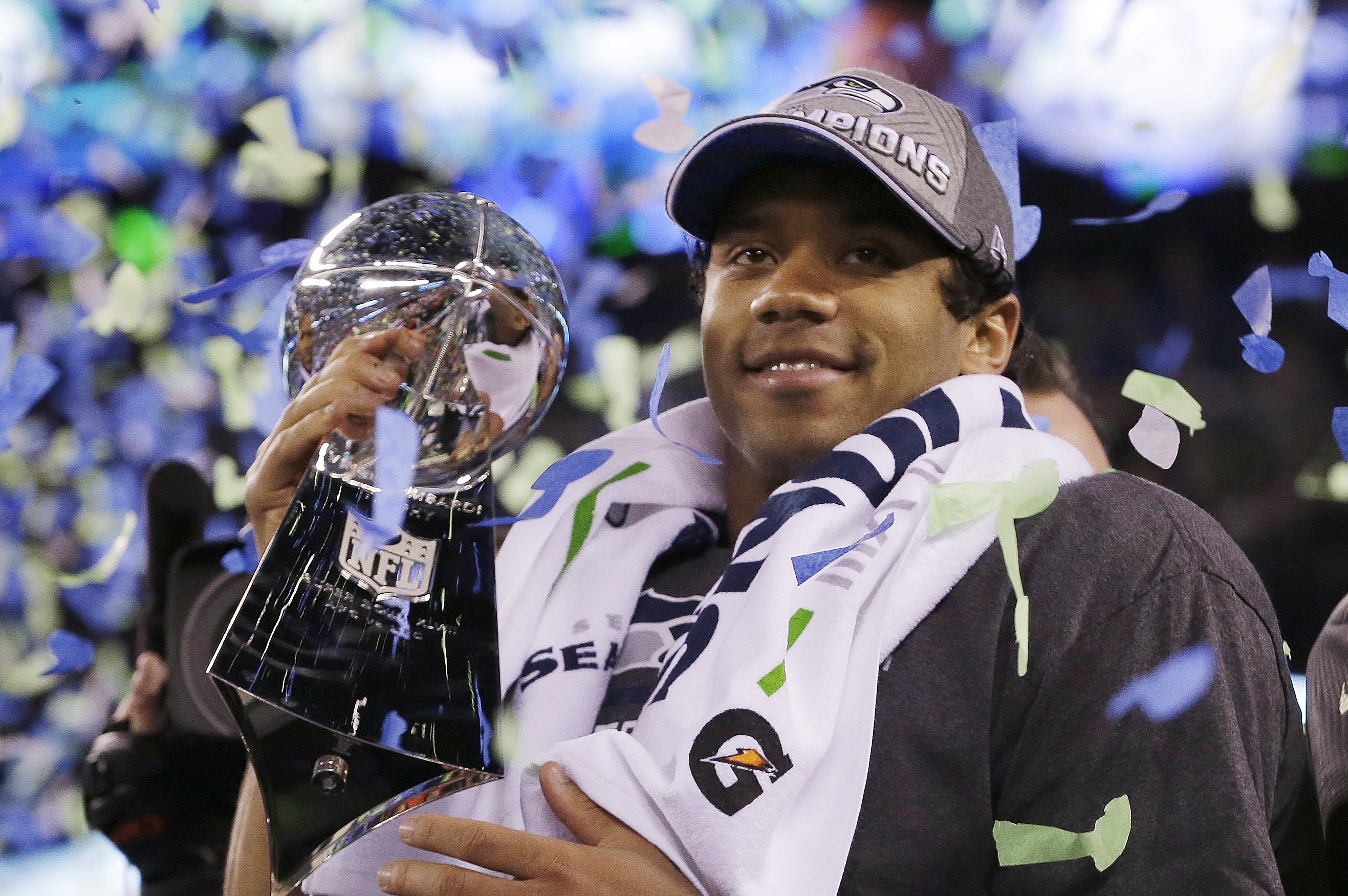 Seattle Seahawks' quarterback Russell Wilson holds the Lombardi Trophy after the NFL Super Bowl XLVIII football game Sunday, Feb. 2, 2014, in East Rutherford, N.J. The Seahawks won 43-8. (AP Photo/Julio Cortez)