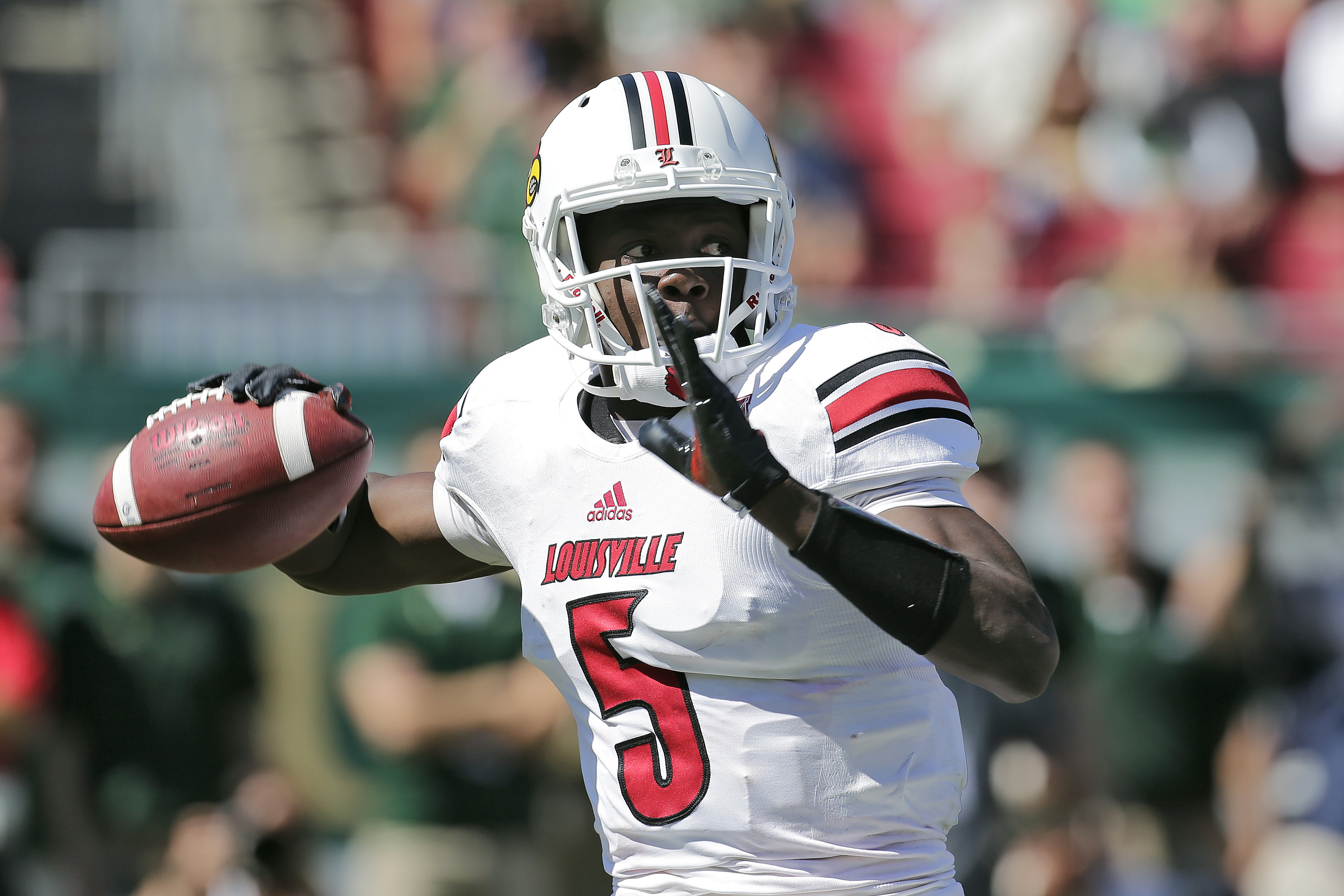 Louisville quarterback Teddy Bridgewater (5) looks for a receiver against South Florida during the first quarter of an NCAA college football game Saturday, Oct. 26, 2013, in Tampa, Fla. (AP Photo/Chris O'Meara)
