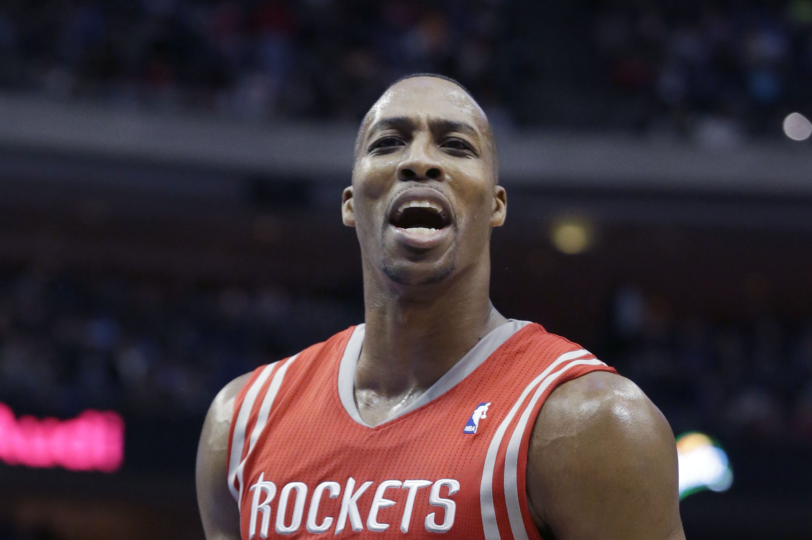 Houston Rockets center Dwight Howard (12) yells to fans during the second half of an NBA basketball game against the Dallas Mavericks Wednesday, Jan. 29, 2014, in Dallas.  (AP Photo/LM Otero)