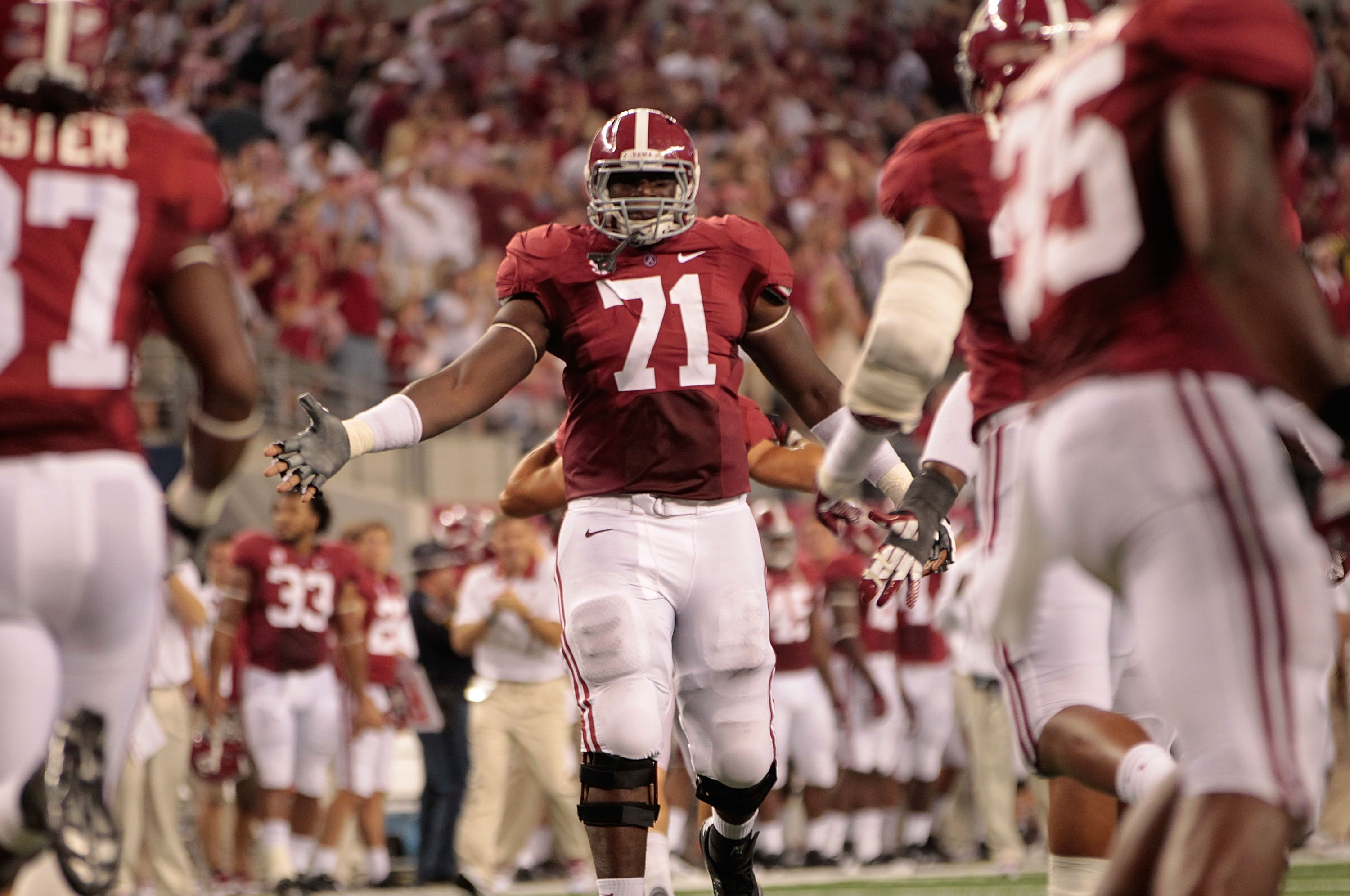 ARLINGTON, TX - SEPTEMBER 01: Cyrus Kouandjio #71 of the University of Alabama reacts after a big stop during the game against the University of Michigan at Cowboys Stadium on September 1, 2012 in Arlington, Texas. Alabama defeated Michigan 41-14.  (Photo by Leon Halip/Getty Images)
