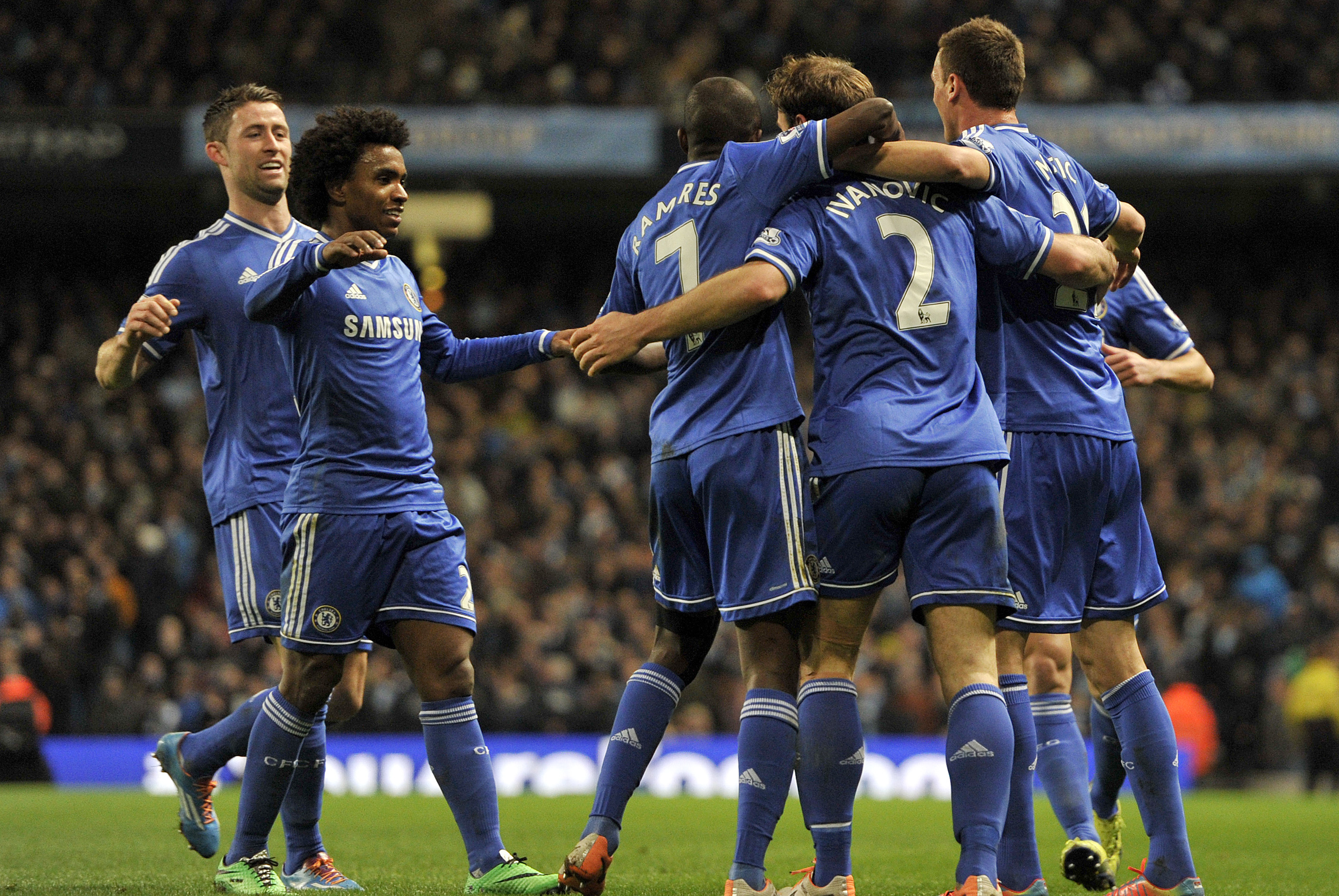 Chelsea's Branislav Ivanovic, fourth left, celebrates with his team-mates after he scored the first goal of the game for his side during their English Premier League soccer match against Manchester City at the Etihad stadium in Manchester, England, Monday Feb. 3, 2014. (AP Photo/Clint Hughes)