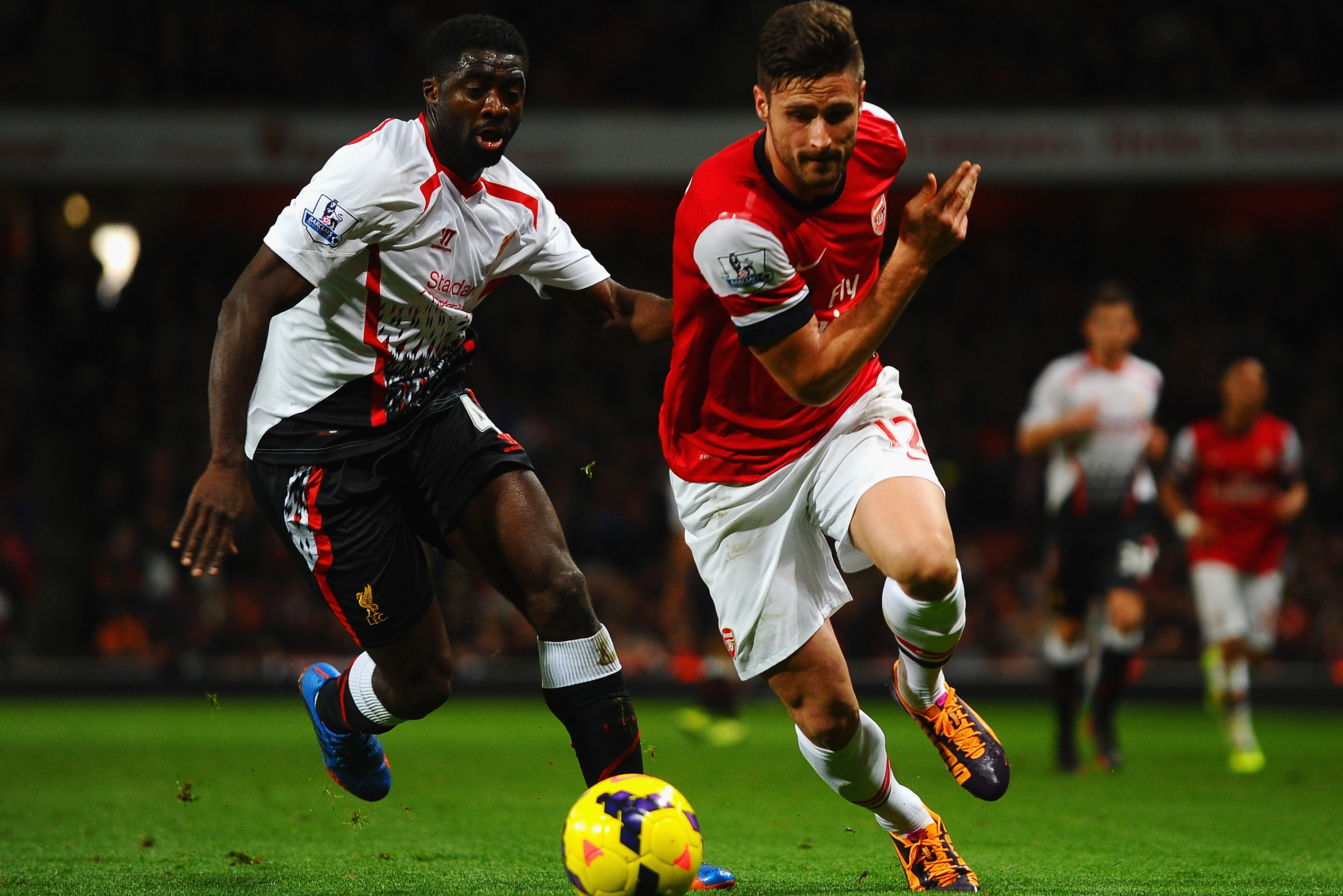 LONDON, ENGLAND - NOVEMBER 02: Kolo Toure of Liverpool marshalls Olivier Giroud of Arsenal during the Barclays Premier League match between Arsenal and Liverpool at Emirates Stadium on November 2, 2013 in London, England.  (Photo by Laurence Griffiths/Getty Images)
