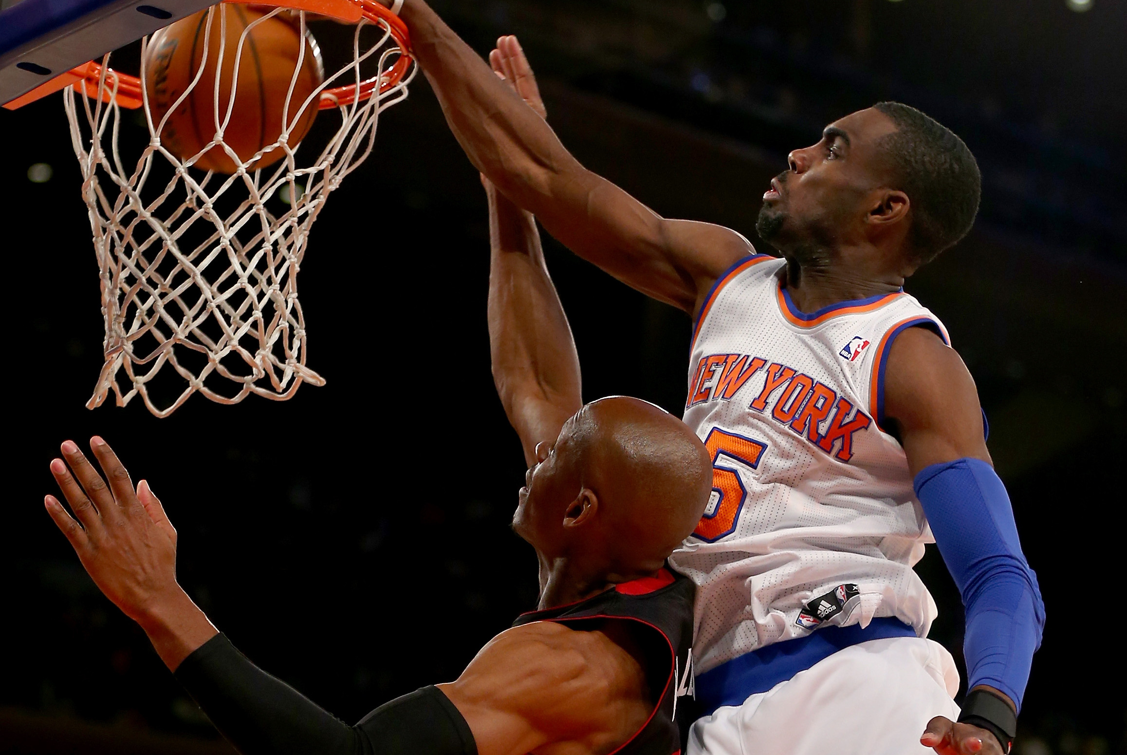 NEW YORK, NY - JANUARY 09:  Tim Hardaway Jr. #5 of the New York Knicks dunks the ball over Ray Allen #34 of the Miami Heat at Madison Square Garden on January 9, 2014 in New York City.The New York Knicks defeated the Miami Heat 102-92. NOTE TO USER: User expressly acknowledges and agrees that, by downloading and/or using this photograph, user is consenting to the terms and conditions of the Getty Images License Agreement.  (Photo by Elsa/Getty Images)