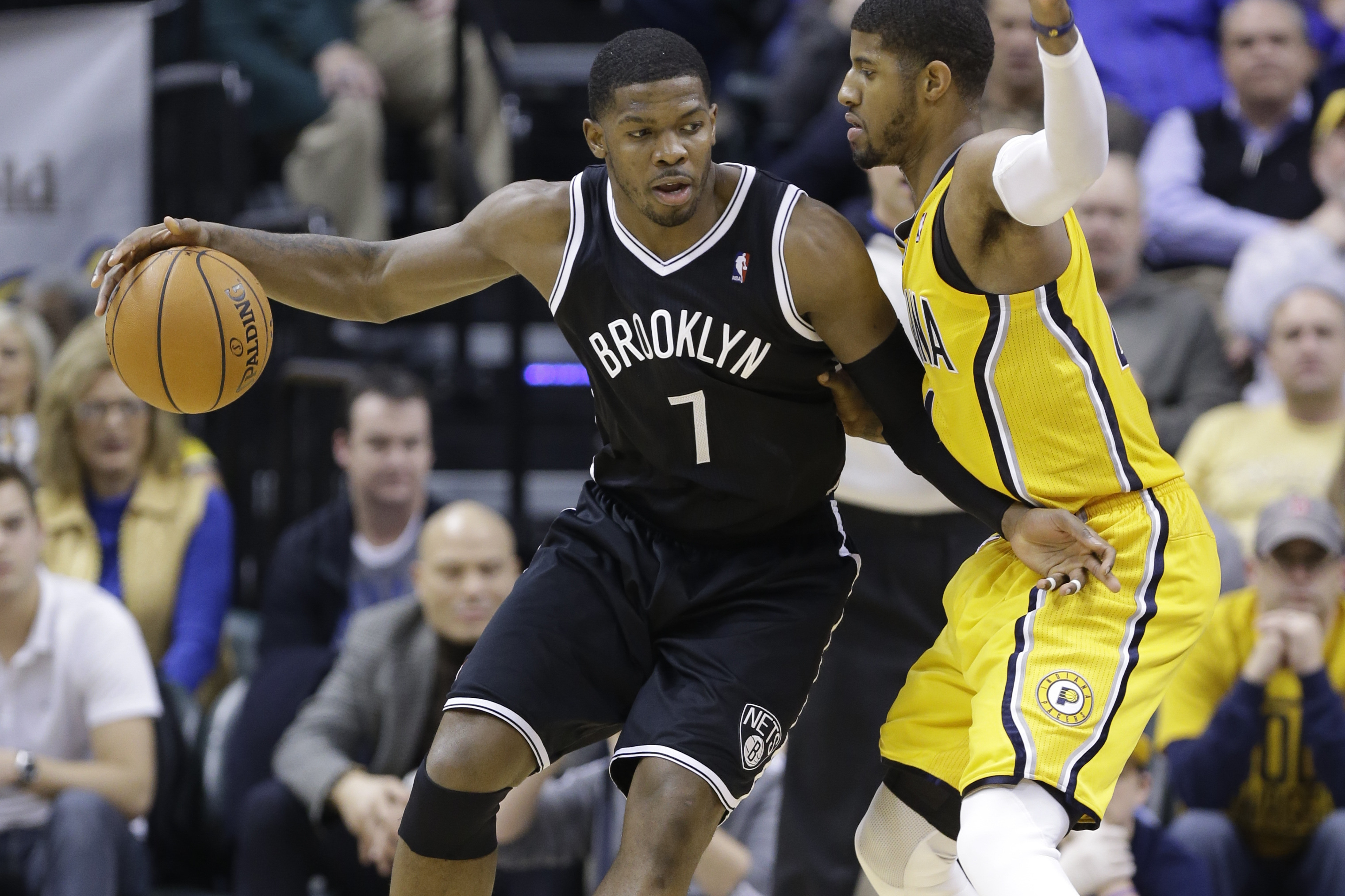 Brooklyn Nets guard Joe Johnson, left, drives on Indiana Pacers forward Paul George in the second half of an NBA basketball game in Indianapolis, Saturday, Feb. 1, 2014. The Pacers defeated the Nets 97-96. (AP Photo/Michael Conroy)