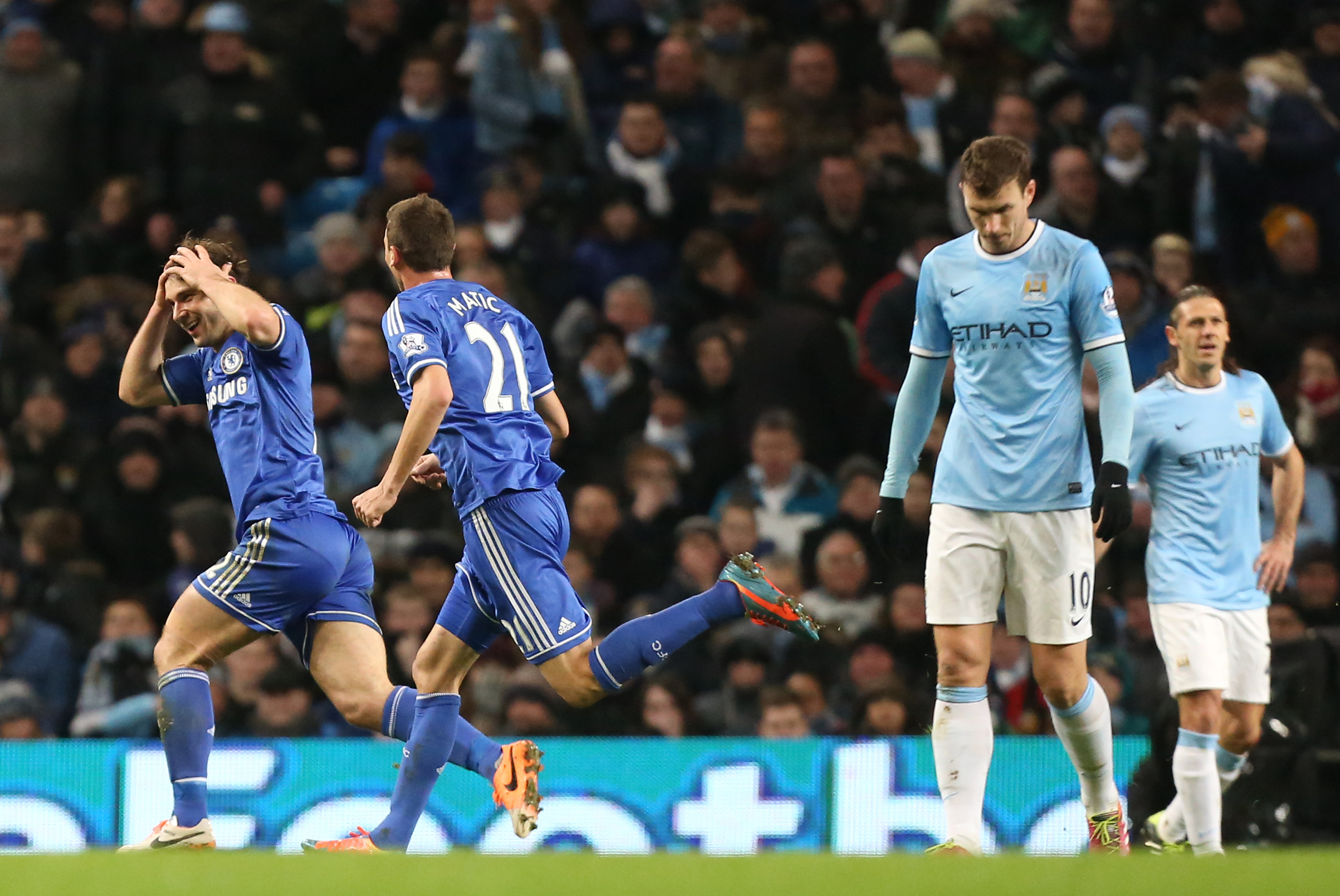 Chelsea's Branislav Ivanovic, left, celebrates after scoring the opening during their English Premier League soccer match between Manchester City and Chelsea at the Etihad Stadium, Manchester, England, Monday Feb. 3, 2014. (AP Photo/Jon Super)
