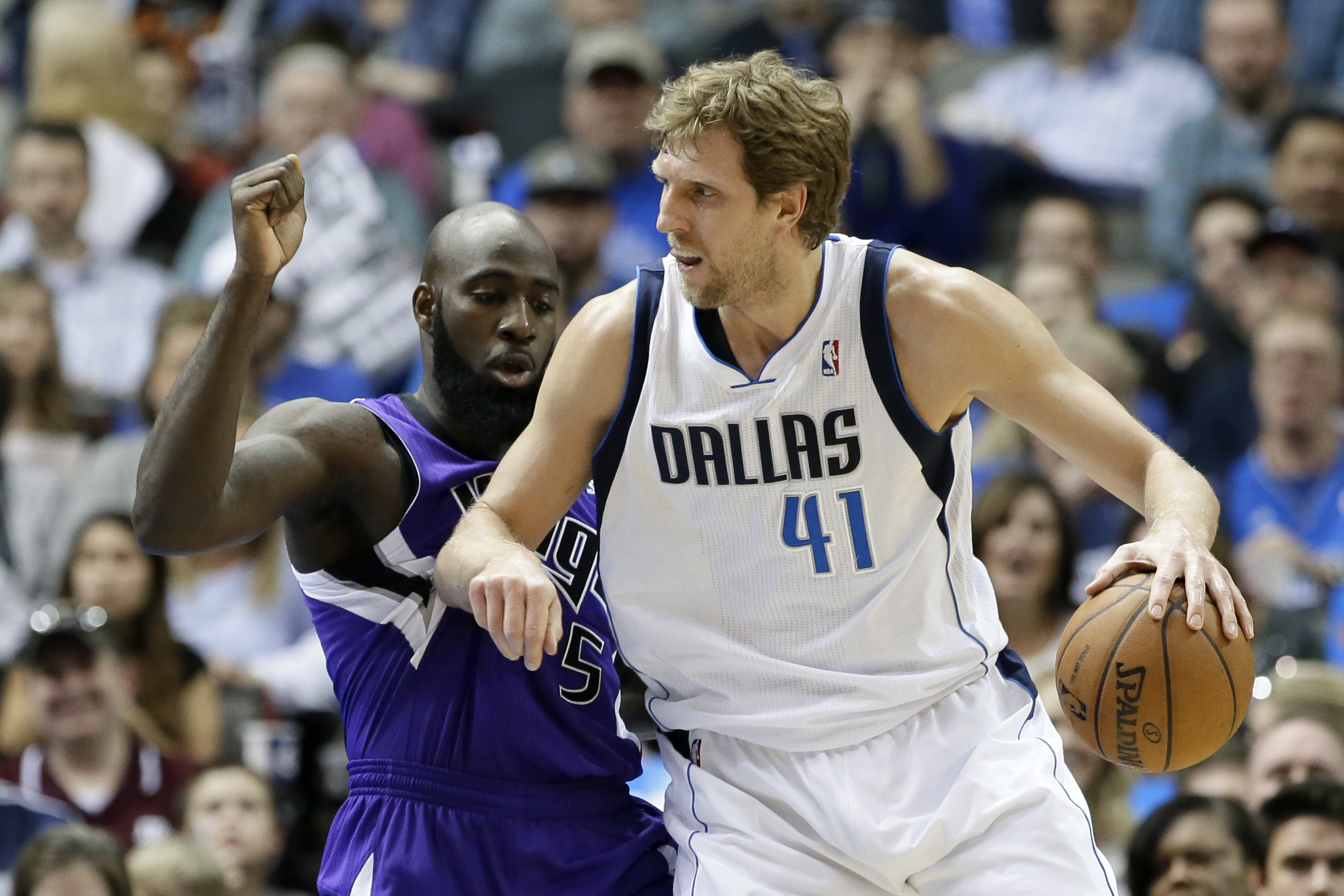 Dallas Mavericks' Dirk Nowitzki (41) positions against Sacramento Kings' Quincy Acy for an opening to the basket in the first half of an NBA basketball game, Friday, Jan. 31, 2014, in Dallas. (AP Photo/Tony Gutierrez)