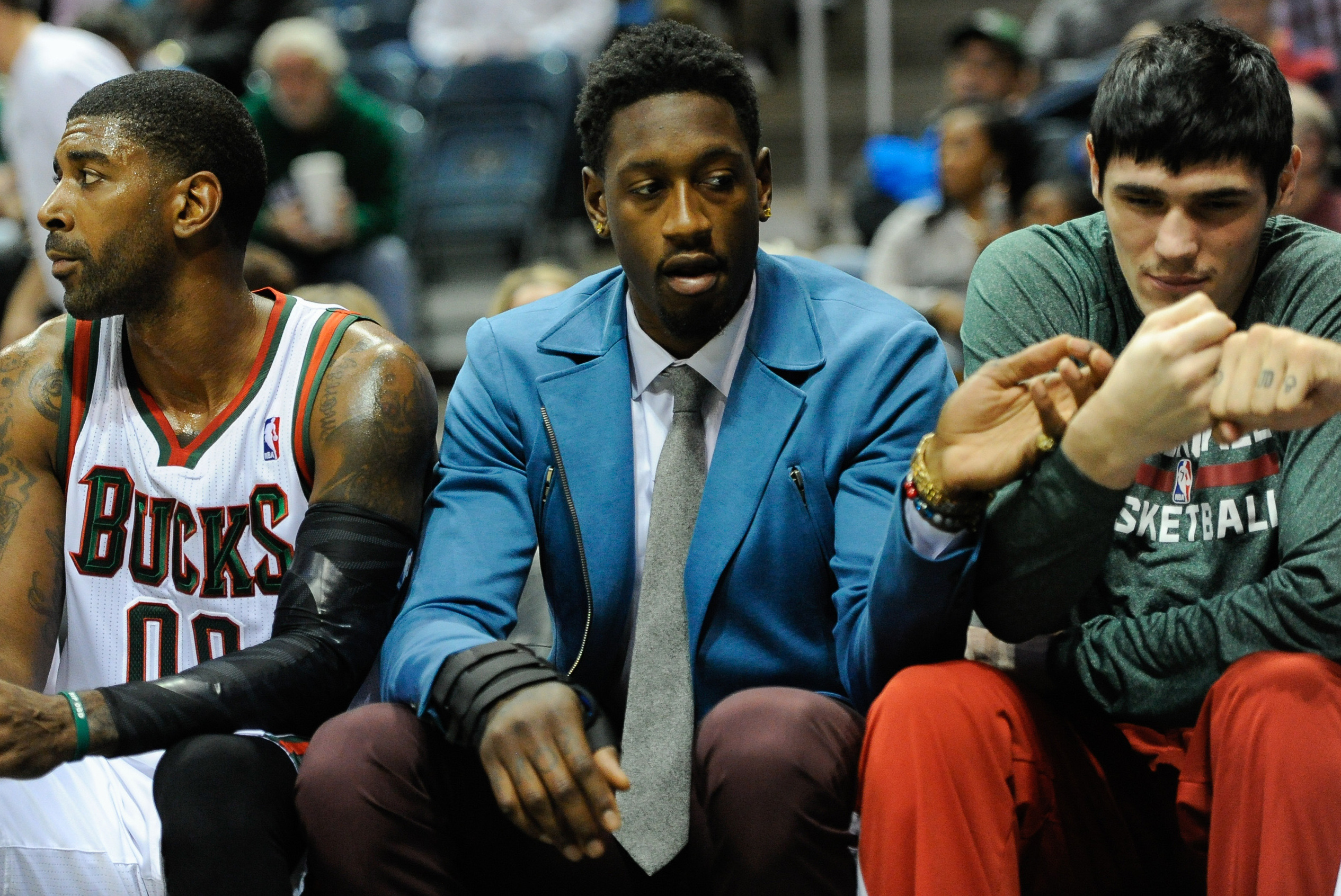 Nov 9, 2013; Milwaukee, WI, USA;  Milwaukee Bucks center Larry Sanders (center) sits on the bench with guard O.J. Mayo (left) and forward Ersan Ilyasova (right) in the 2nd quarter at BMO Harris Bradley Center. Sanders did not play after suffering a hand injury in an off-court incident.  Mandatory Credit: Benny Sieu-USA TODAY Sports