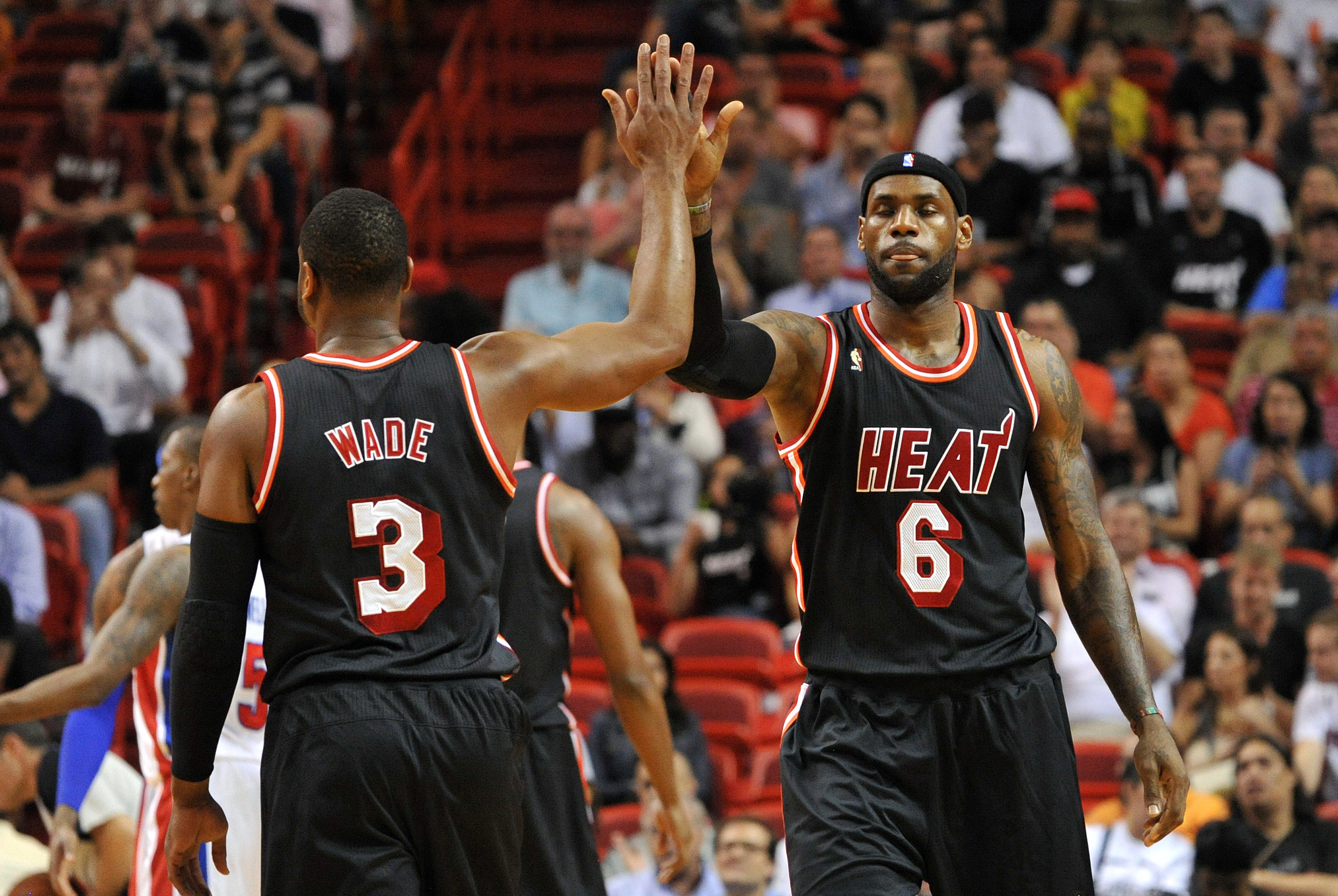 Feb 3, 2014; Miami, FL, USA; Miami Heat small forward LeBron James (right) high fives teammate shooting guard Dwyane Wade (left) during the first half against the Detroit Pistons at American Airlines Arena. Mandatory Credit: Steve Mitchell-USA TODAY Sports