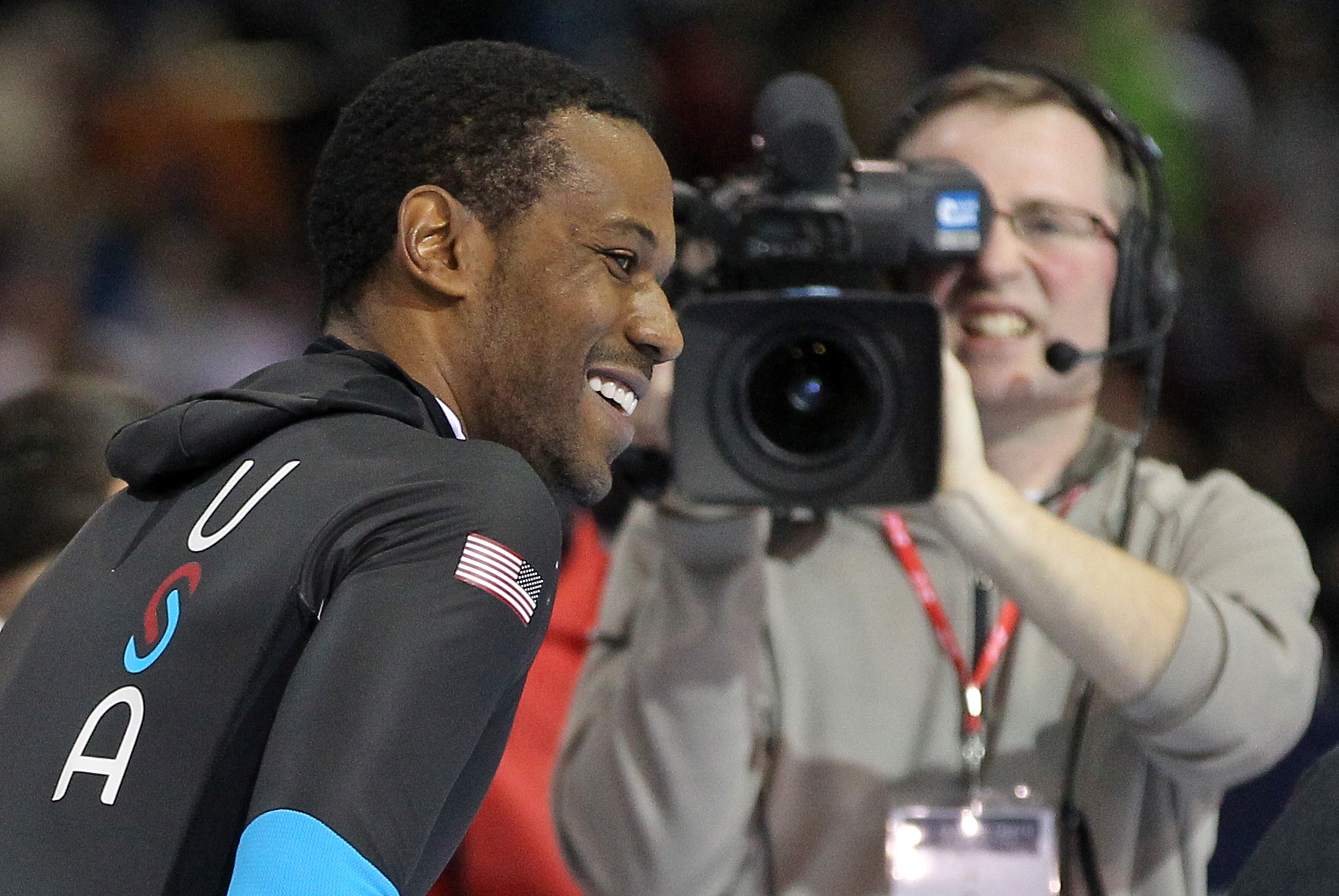 Shani Davis smiles after competing in the men's 1,500 meters during the U.S. Olympic speedskating trials Tuesday, Dec. 31, 2013, in Kearns, Utah. Davis won the event. (AP Photo/Rick Bowmer)