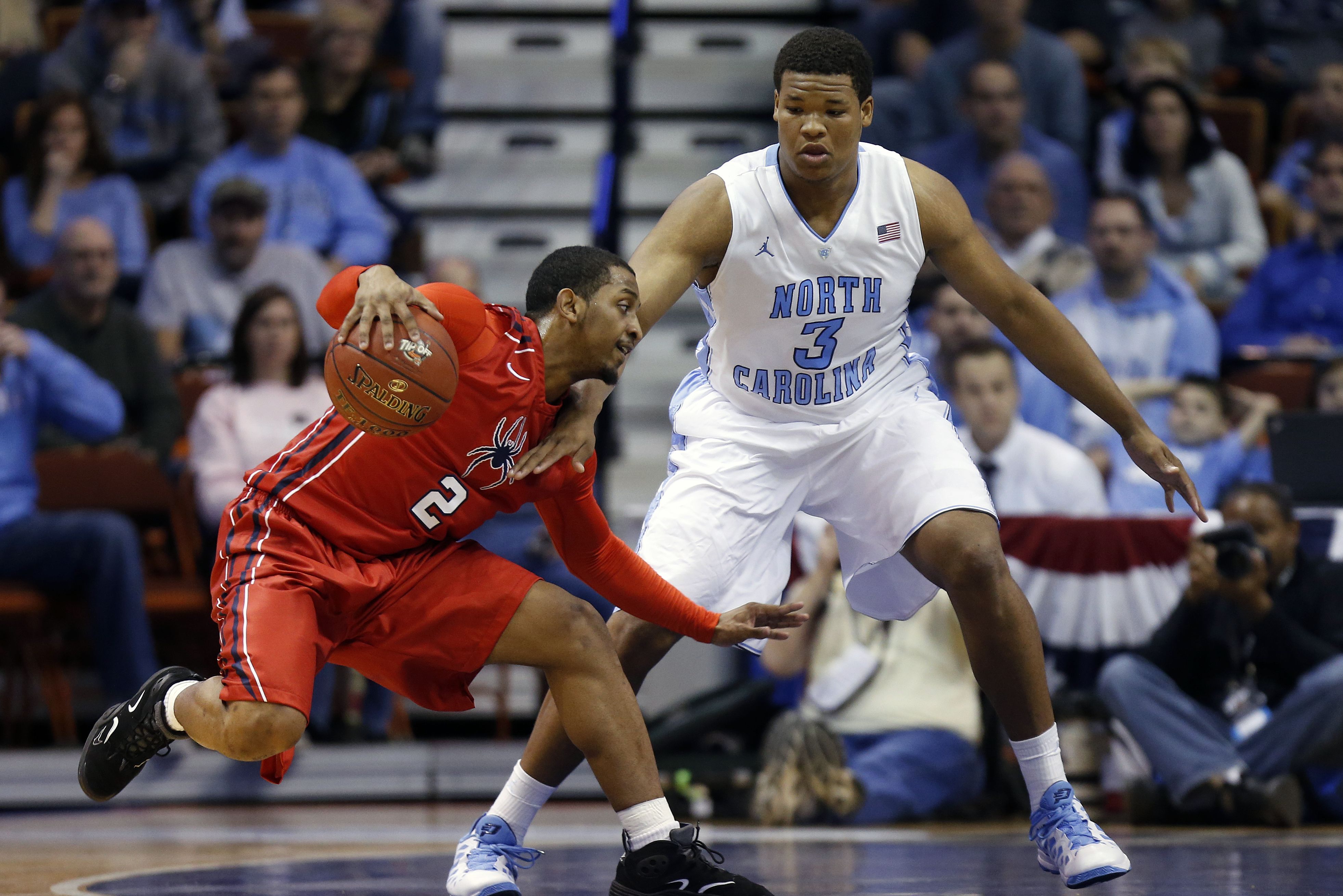 North Carolina's Kennedy Meeks (3) defends against Richmond's Cedrick Lindsay (2) during the first half of an NCAA college basketball game in the semifinal round of the Basketball Hall of Fame Tip-Off tournament at Mohegan Sun Arena in Uncasville, Conn., Saturday, Nov. 23, 2013. (AP Photo/Michael Dwyer)