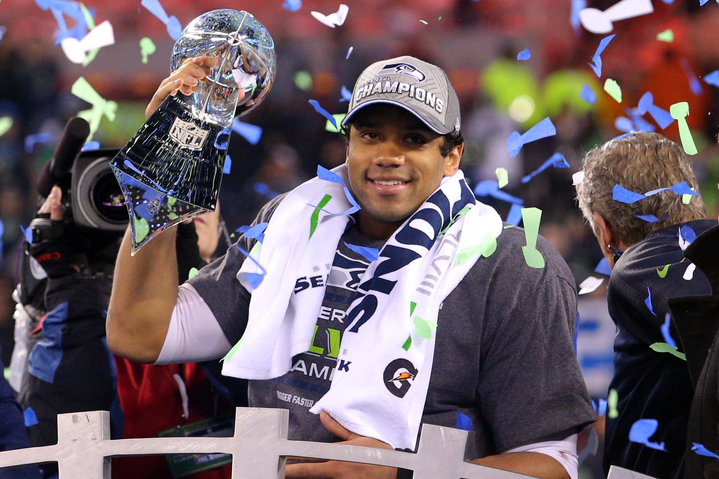 Feb 2, 2014; East Rutherford, NJ, USA; Seattle Seahawks quarterback Russell Wilson (3) celebrates with the Lombardi Trophy after beating the Denver Broncos 43-8 in Super Bowl XLVIII at MetLife Stadium.  Mandatory Credit: Brad Penner-USA TODAY Sports