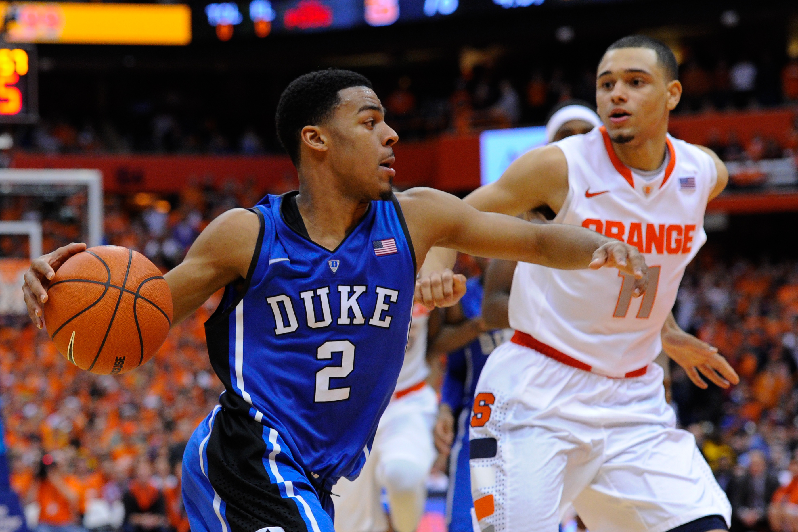 SYRACUSE, NY - FEBRUARY 01:  Quinn Cook #2 of the Duke Blue Devils drives to the basket past Tyler Ennis #11 of the Syracuse Orange during overtime at the Carrier Dome on February 1, 2014 in Syracuse, New York. Syracuse defeated Duke 91-89 in overtime.  (Photo by Rich Barnes/Getty Images)