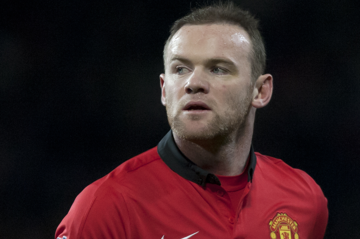 Manchester United's Wayne Rooney runs downfield during his team's 2-0 win against Cardiff City in their English Premier League soccer match at Old Trafford Stadium, Manchester, England, Tuesday Jan. 28, 2014. (AP Photo/Jon Super)