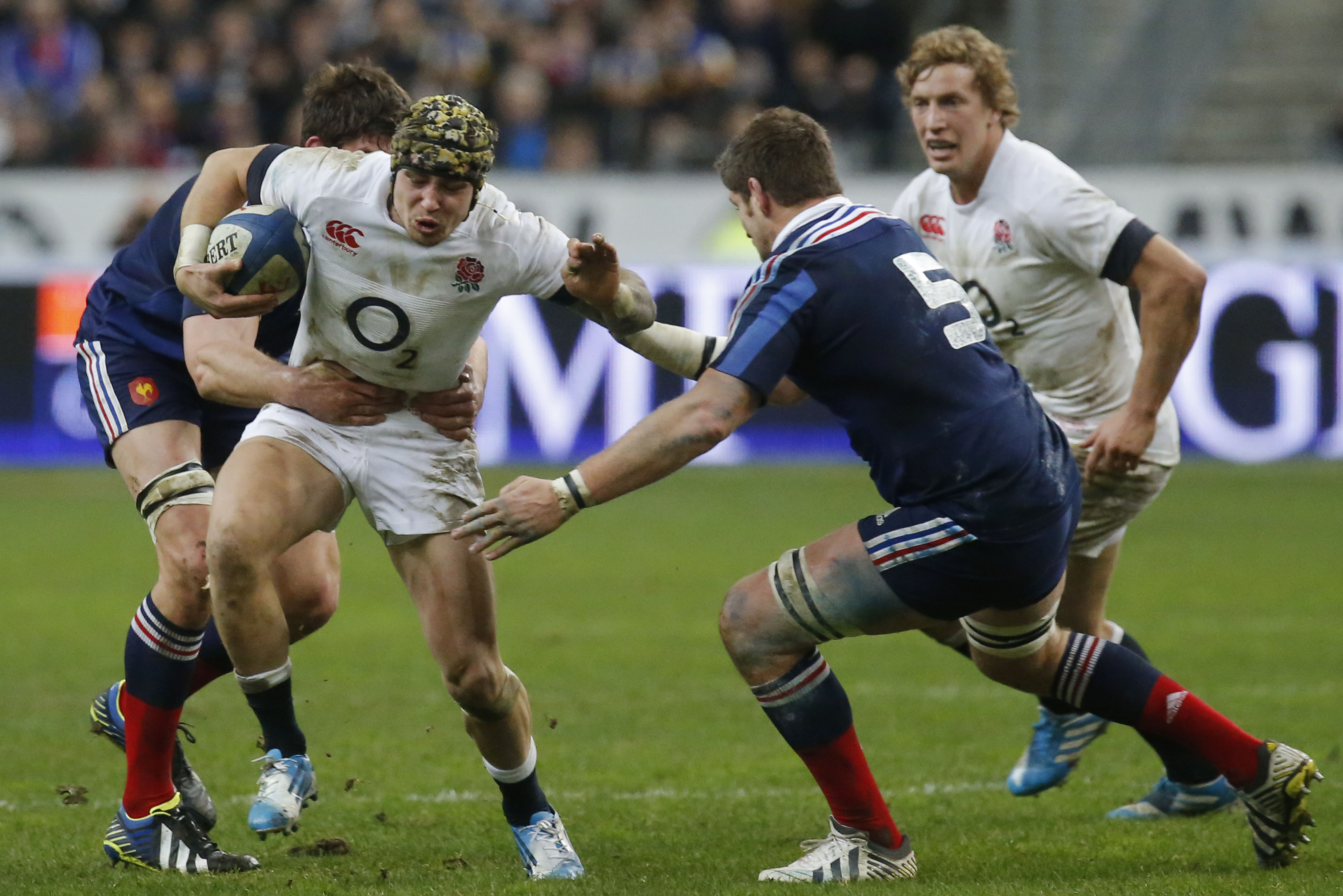 England's Jack Nowell, center, is tackled by France's Alexandre Flanquart, left, and Pascale Pape, right, during their Six Nations international rugby union match between France and England at Stade de France stadium in Saint Denis, near Paris, Saturday, Feb. 1, 2014. (AP Photo/Michel Euler)