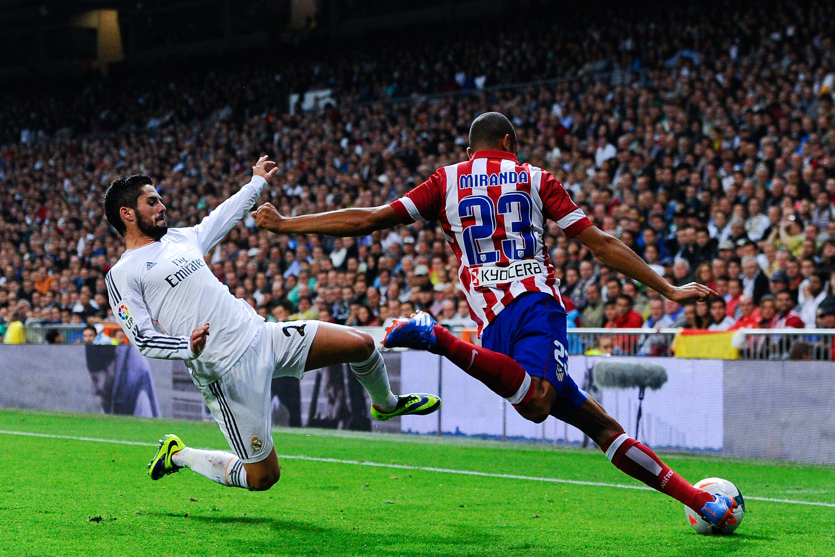 MADRID, SPAIN - SEPTEMBER 28:  Joao Miranda of Atletico de Madrid clear the ball under pressure from Francisco Alarcon Isco of Real Madrid CF during the La Liga match between Real Madrid CF and Club Atletico de Madrid at Bernabeu on September 28, 2013 in Madrid, Spain.  (Photo by David Ramos/Getty Images)