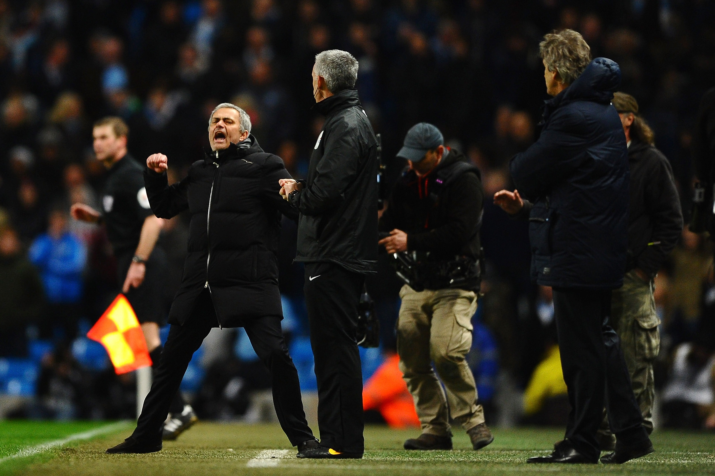 MANCHESTER, ENGLAND - FEBRUARY 03:  Manuel Pellegrini manager of Manchester City (R) looks on as Jose Mourinho manager of Chelsea celebrates at the final whistle during the Barclays Premier League match between Manchester City and Chelsea at Etihad Stadium on February 3, 2014 in Manchester, England.  (Photo by Laurence Griffiths/Getty Images)