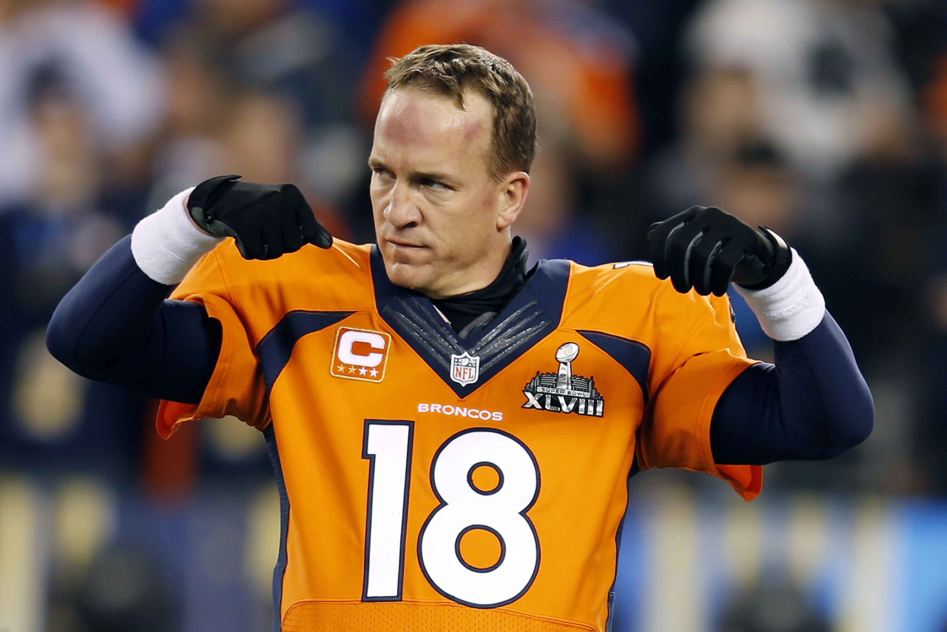 Denver Broncos quarterback Peyton Manning warms up on the field before the NFL Super Bowl XLVIII football game against the Seattle Seahawks Sunday, Feb. 2, 2014, in East Rutherford, N.J. (AP Photo/Evan Vucci)