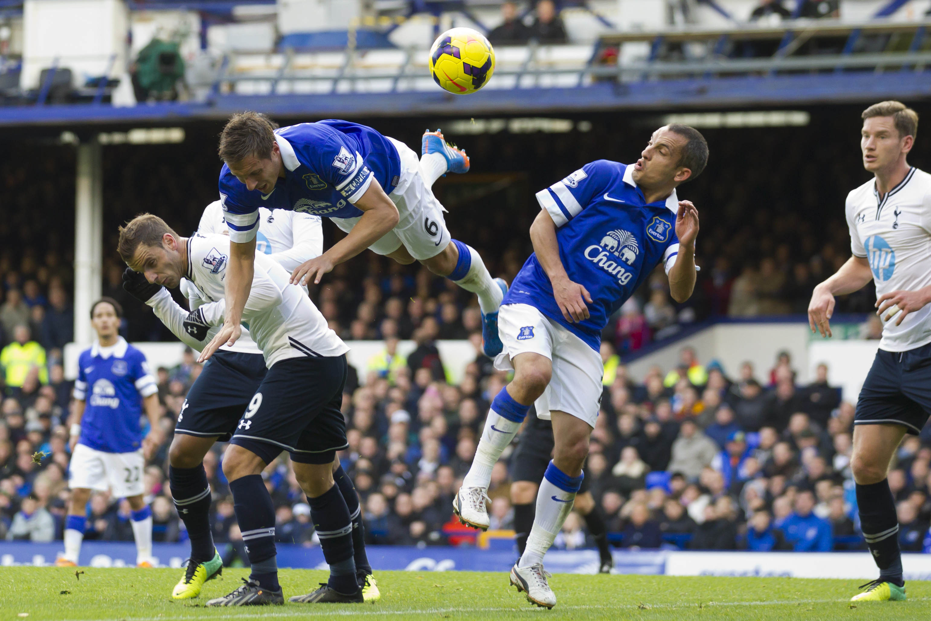 Everton's Philip Jagielka, upper left, and Leon Osman, centre right, head a ball clear during their team's English Premier League soccer match against Tottenham at Goodison Park Stadium, Liverpool, England, Sunday Nov. 3, 2013. (AP Photo/Jon Super)