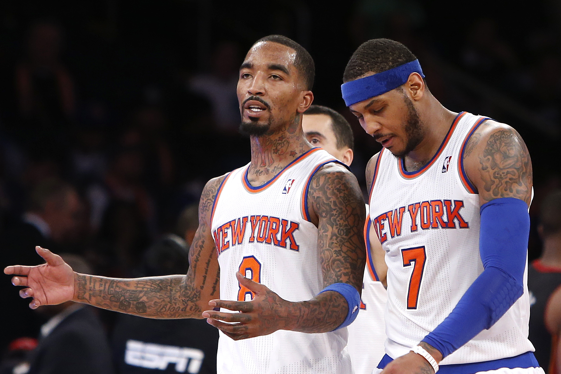 New York Knicks' J.R. Smith (8) talks with teammate Carmelo Anthony (7) as they walk off the court during a timeout late in the fourth quarter of an NBA basketball game against the Miami Heat, Saturday, Feb. 1, 2014, in New York. Miami won 106-91. (AP Photo/Jason DeCrow)