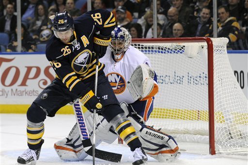 File- This Feb. 23, 2013 file photo shows Buffalo Sabres' left winger Thomas Vanek (26), of Austria, getting ready to deflect the puck in front of New York Islanders' goaltender Evgeni Nabokov (20), of Russia, during the first period of an NHL hockey game in Buffalo, N.Y., The New York Islanders announced Sunday Oct. 27, 2013, that they have acquired Vanek from the Buffalo Sabres in exchange for Matt Moulson, a first round selection in the 2014 NHL draft and a second round selection in 2015. (AP Photo/Gary Wiepert, File)