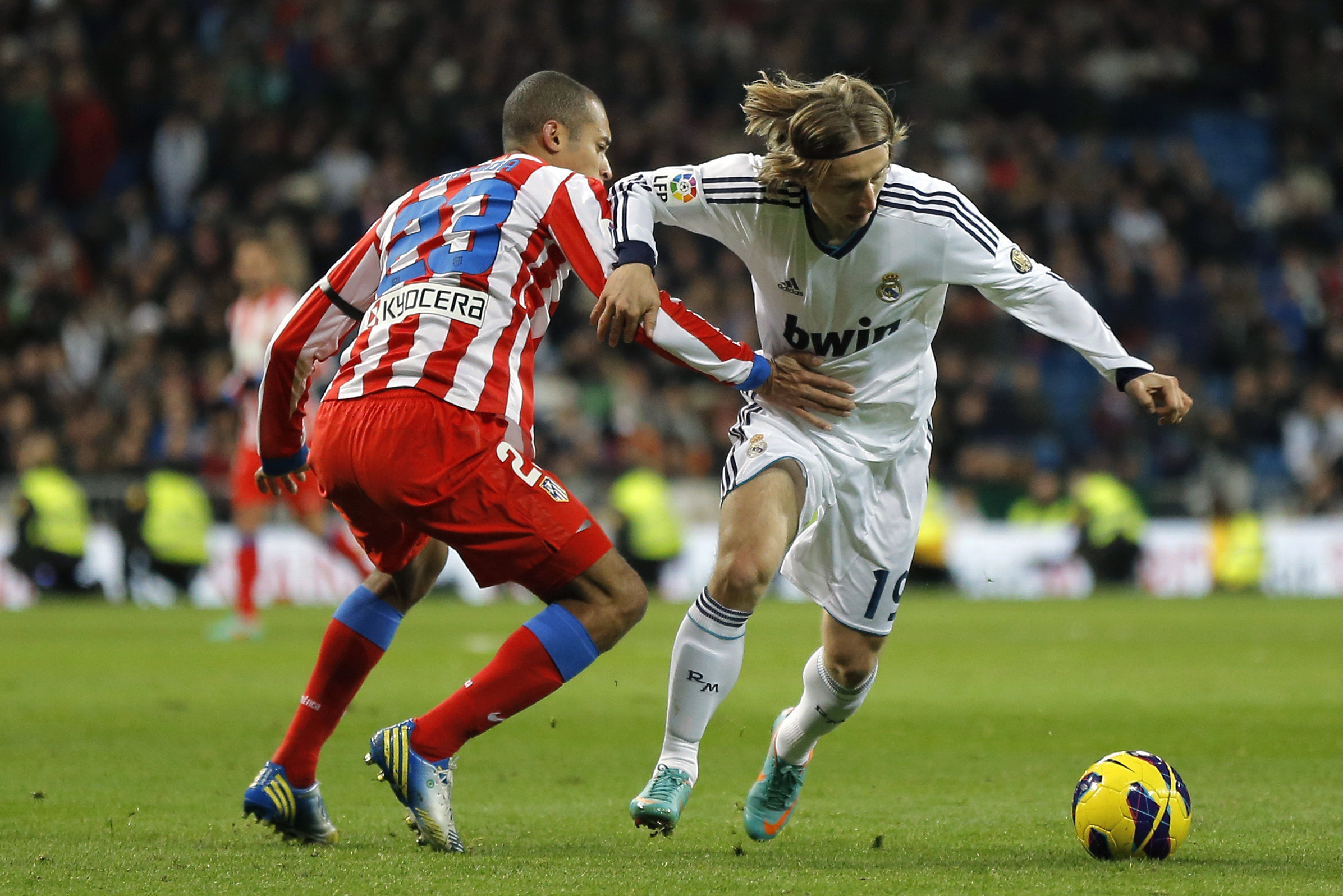 Real Madrid's Luka Modric from Croatia, right, duels for the ball with Atletico de Madrid's Joao Miranda from Brazil during a Spanish La Liga soccer match at the Santiago Bernabeu stadium  in Madrid, Saturday, Dec. 1, 2012. (AP Photo/Daniel Ochoa de Olza)