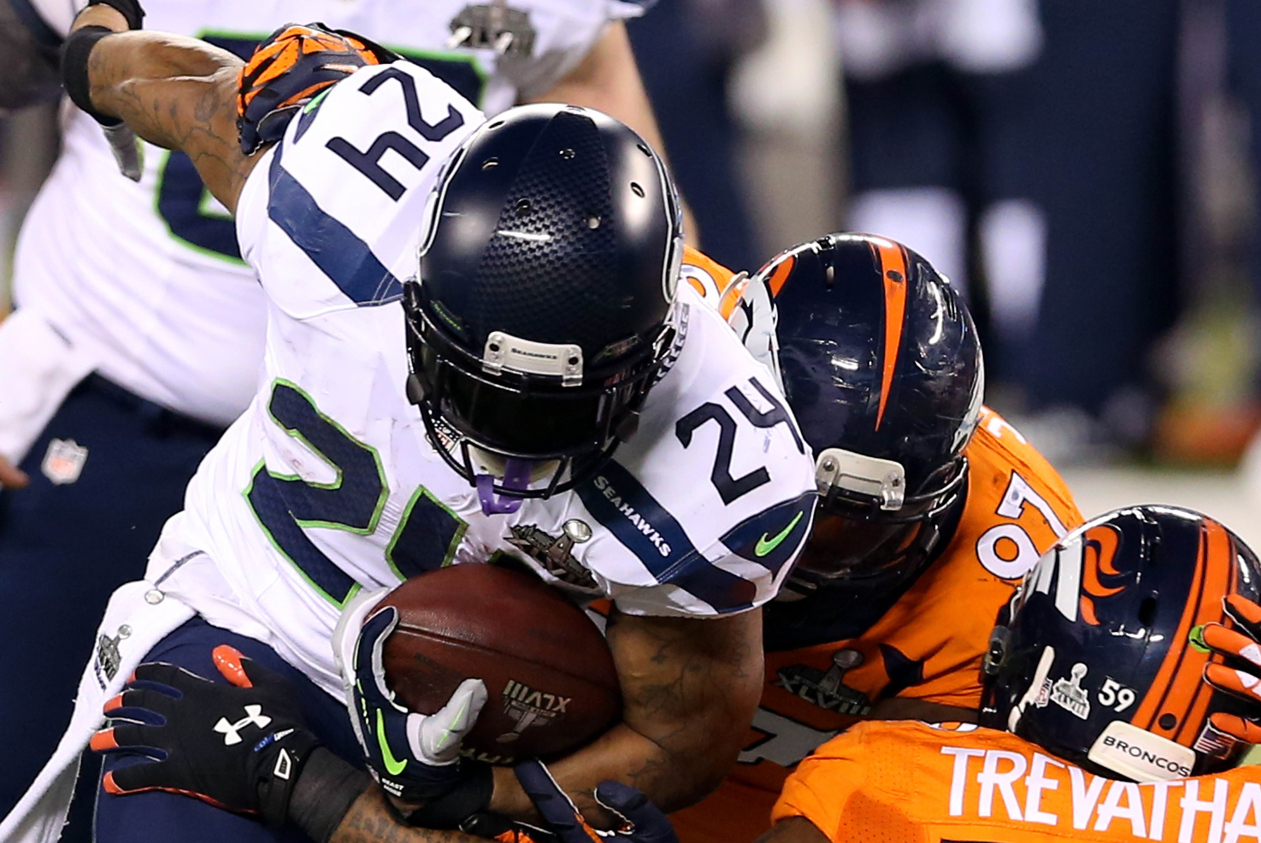 EAST RUTHERFORD, NJ - FEBRUARY 02: Running back Marshawn Lynch #24 of the Seattle Seahawks   runs the ball during Super Bowl XLVIII at MetLife Stadium on February 2, 2014 in East Rutherford, New Jersey.  (Photo by Christian Petersen/Getty Images)