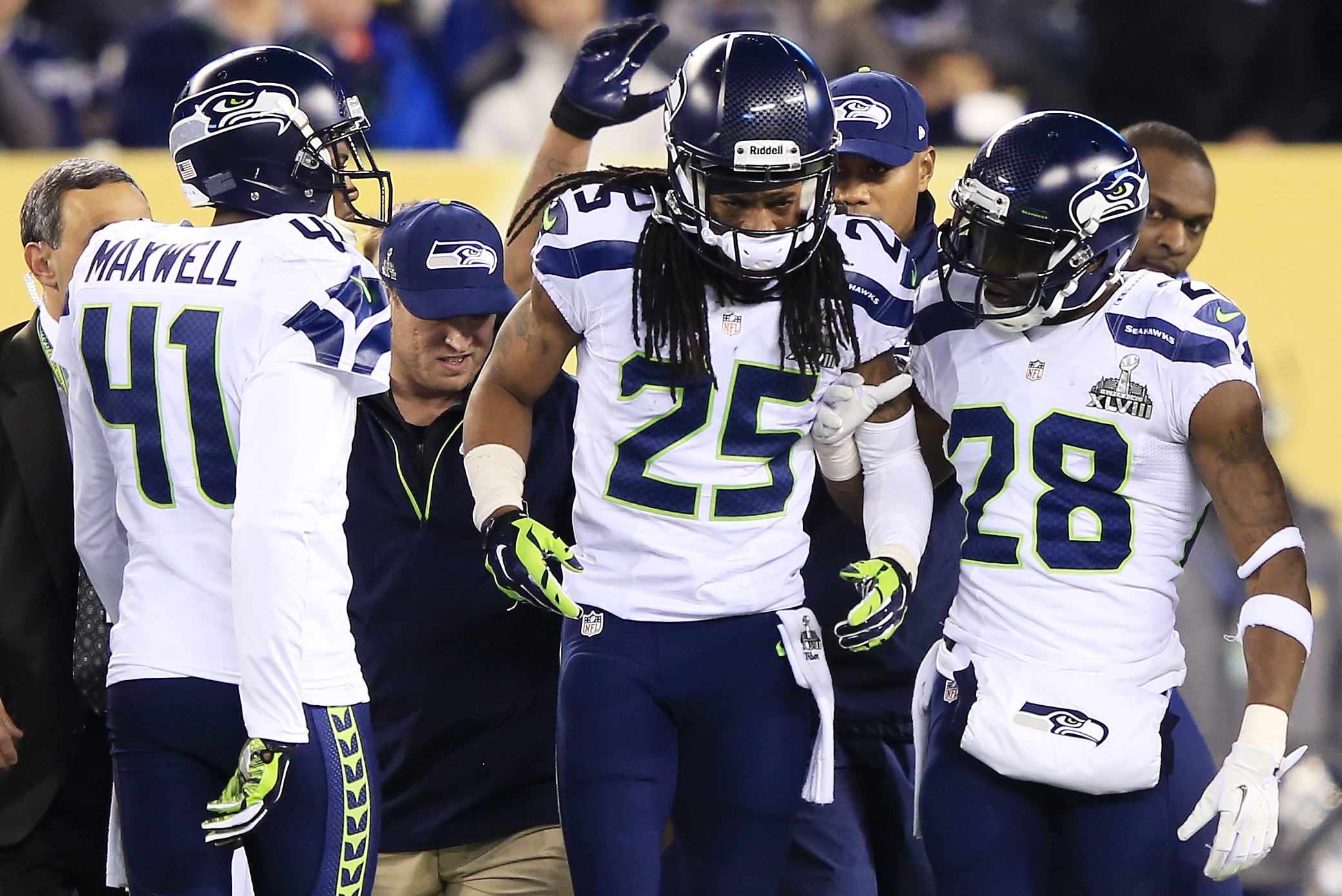 EAST RUTHERFORD, NJ - FEBRUARY 02:  cornerback Richard Sherman #25 of the Seattle Seahawks talks with teammate cornerback Walter Thurmond #28 during Super Bowl XLVIII against the Denver Broncos at MetLife Stadium on February 2, 2014 in East Rutherford, New Jersey. The Seattle Seahawks won 43-8. (Photo by Jamie Squire/Getty Images)