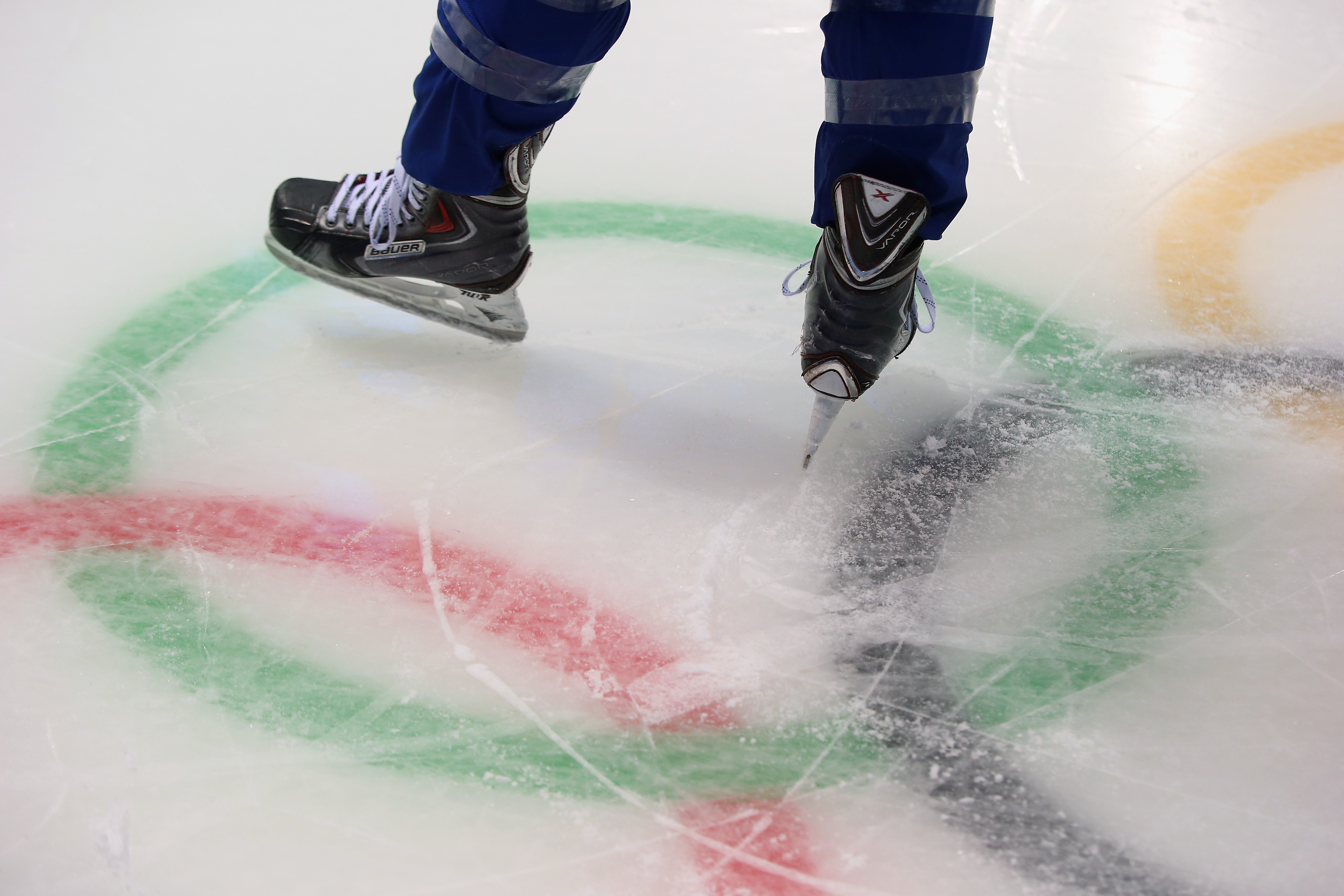 SOCHI, RUSSIA - FEBRUARY 03: A member of the United States women's ice hockey team skates over the Olympic rings logo during a practice session ahead of the Sochi 2014 Winter Olympics at Shayba Arena on February 3, 2014 in Sochi, Russia.  (Photo by Bruce Bennett/Getty Images)