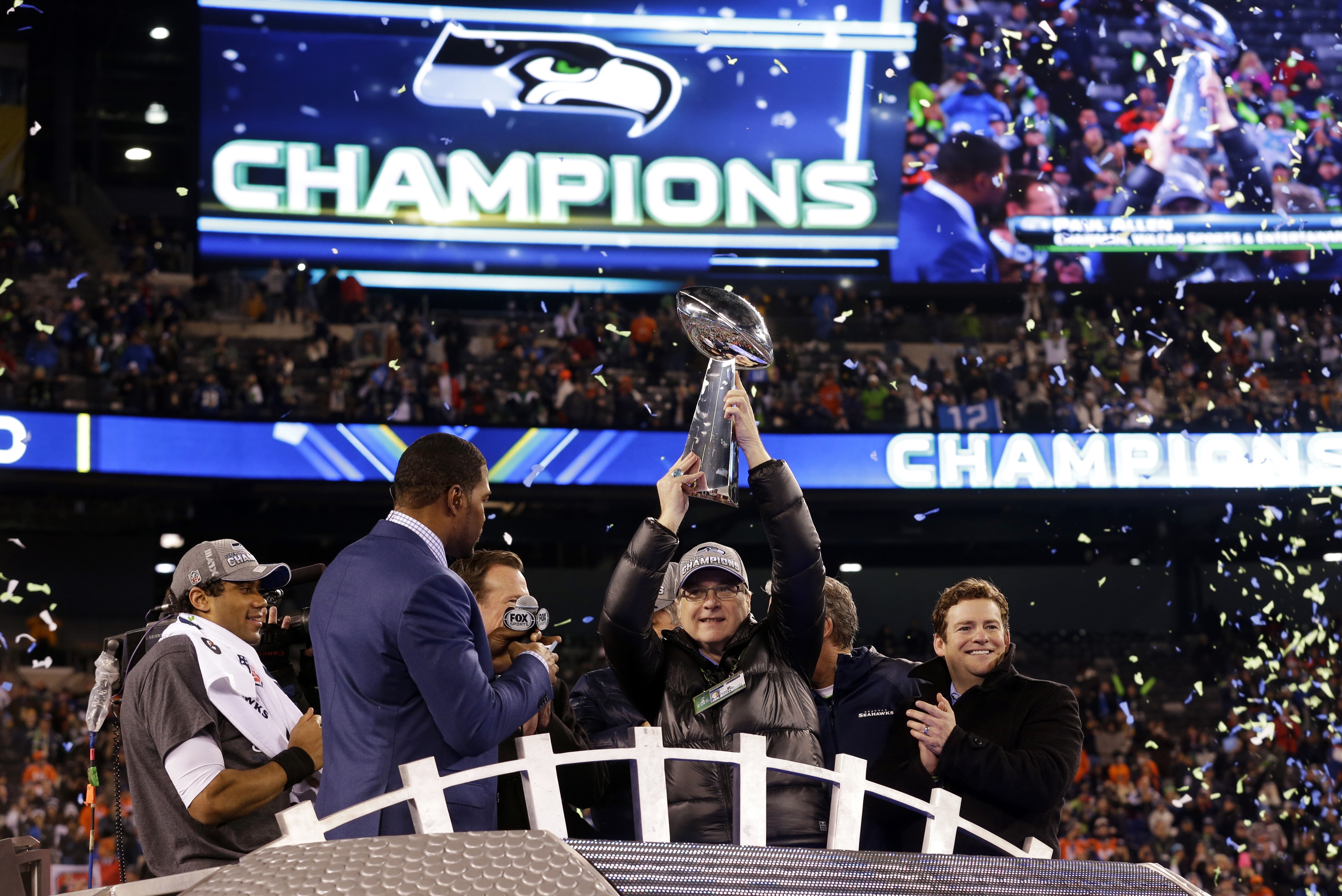 Seattle Seahawks owner Paul Allen raises the Vince Lombardi Trophy after the NFL Super Bowl XLVIII football game against the Denver Broncos, Sunday, Feb. 2, 2014, in East Rutherford, N.J. The Seahawks won 43-8. (AP Photo/Ted S. Warren)